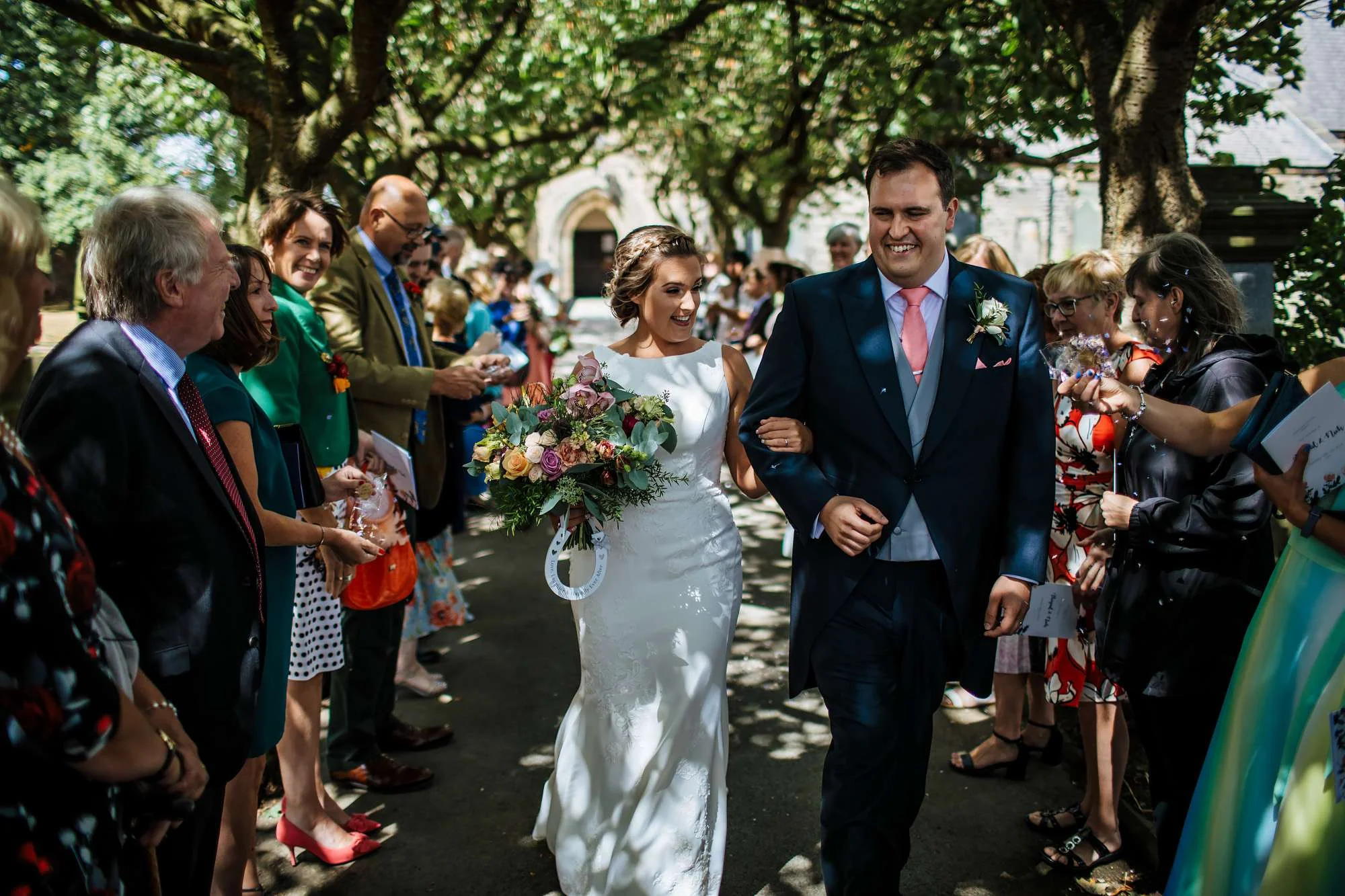 Bride and groom laughing outside the church in Huddersfield