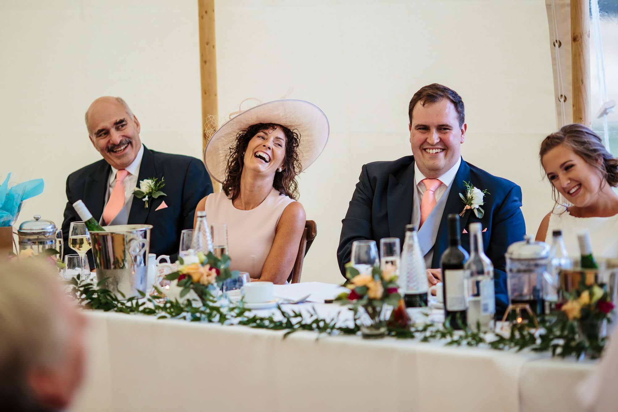 Groom and his mum laughing during his wedding speeches