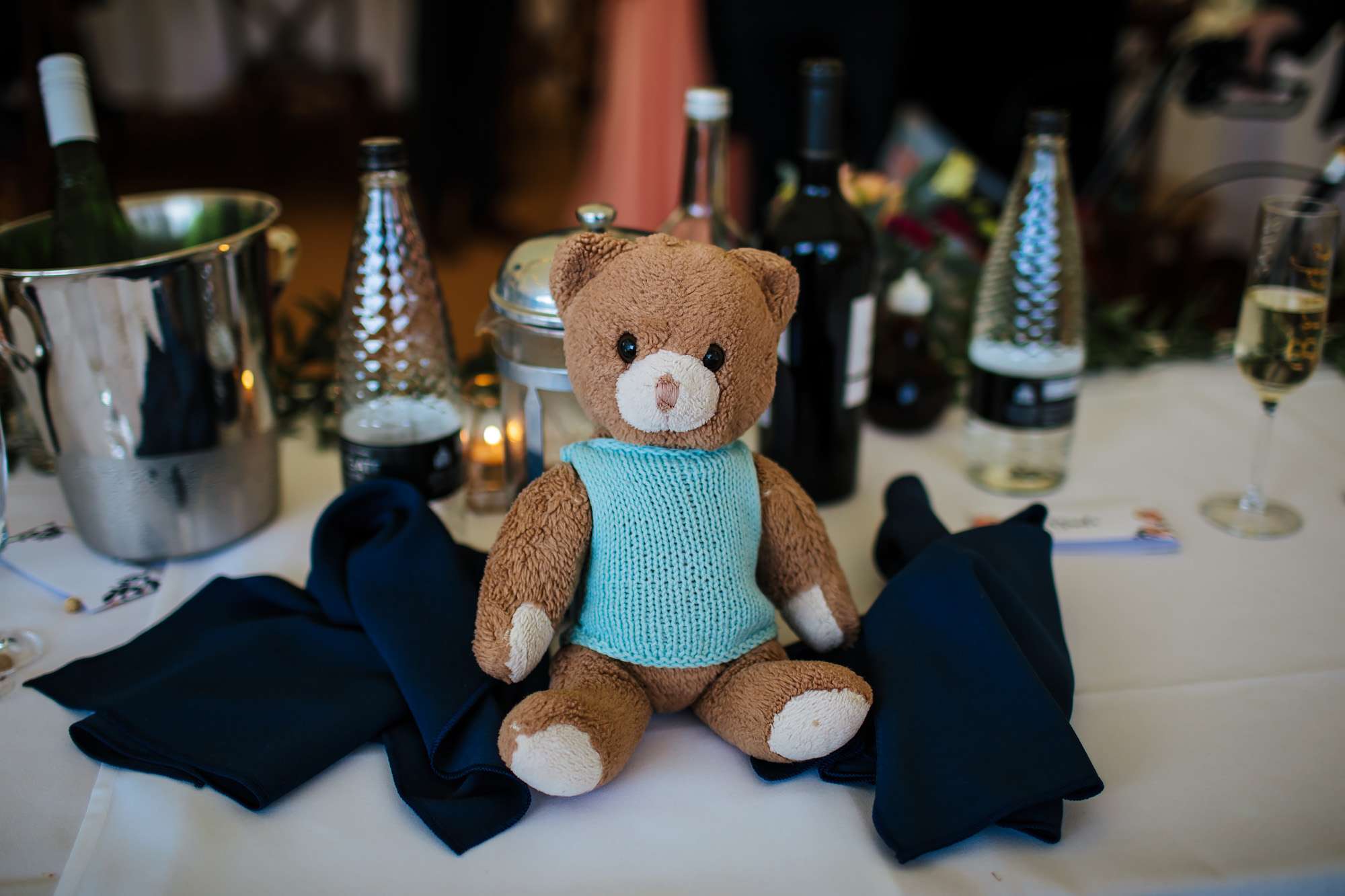 Teddy bear sitting on the table at a wedding