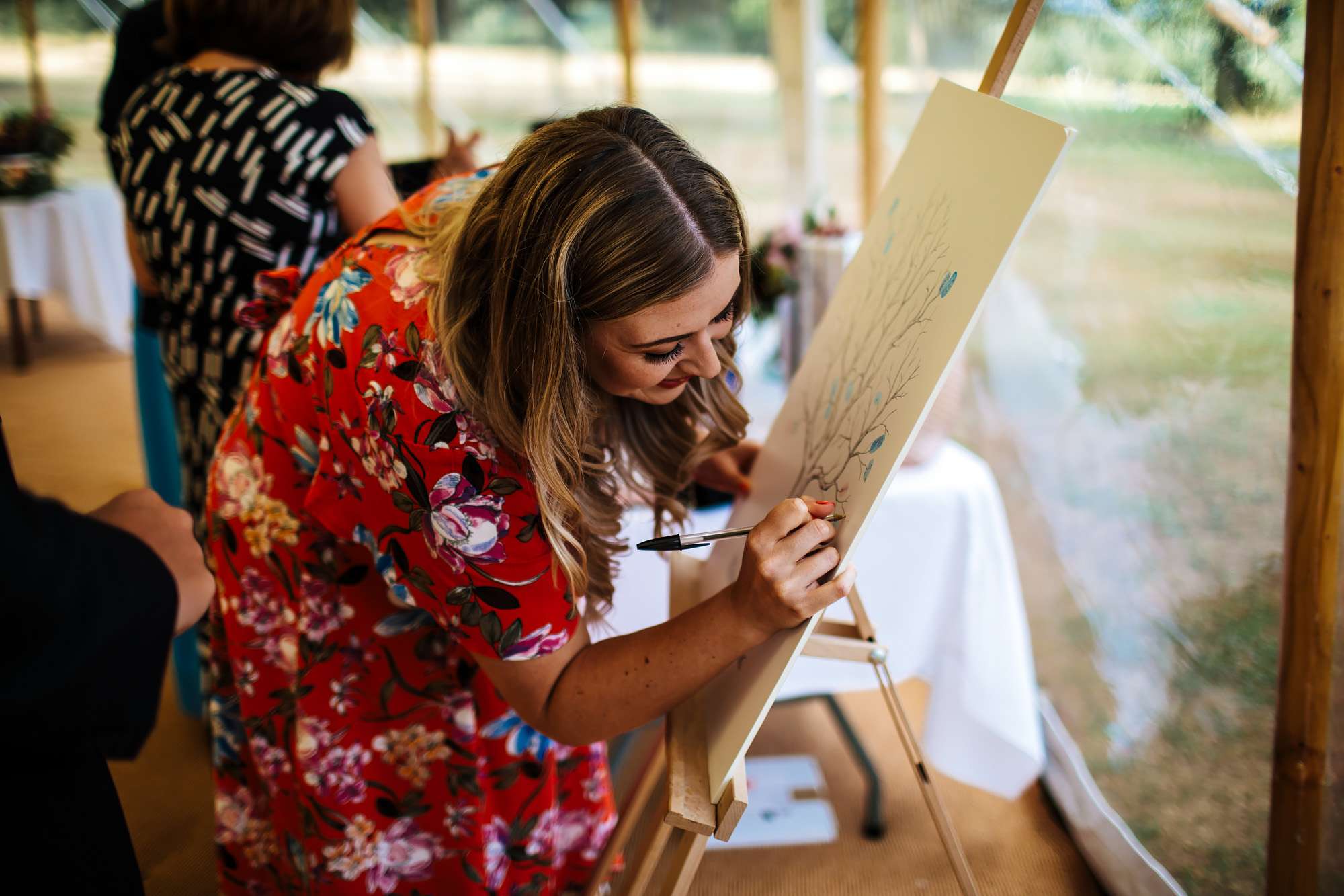 Guests writing on the wedding sign in Yorkshire