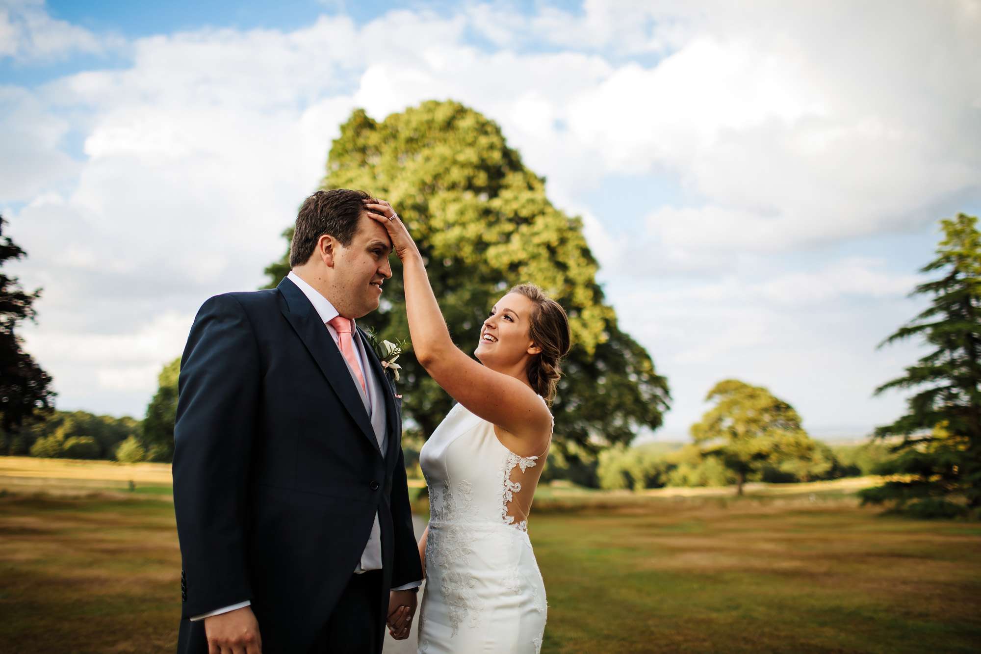 Bride adjusting the groom's hair at a Yorkshire wedding