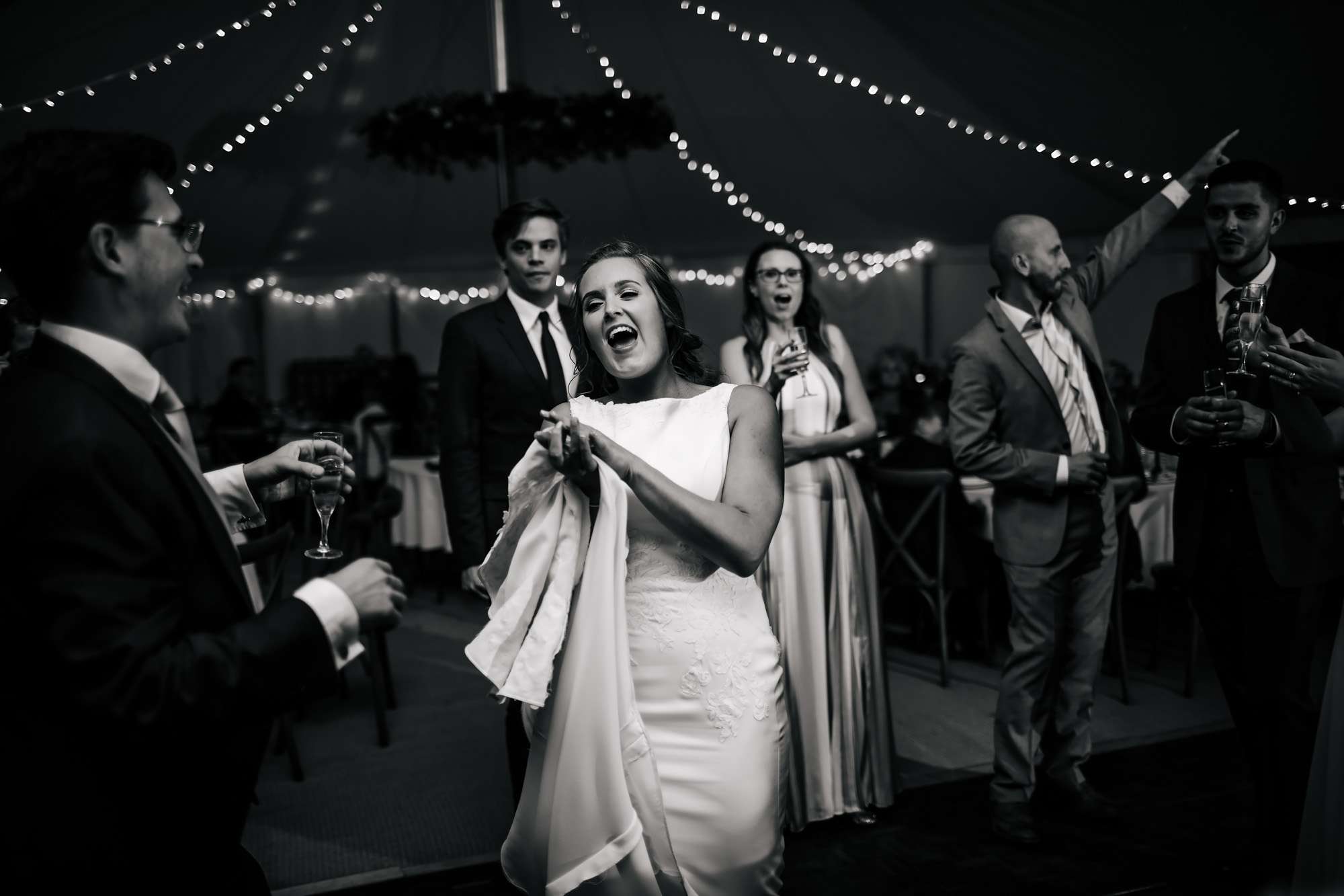 Bride laughing on the dance floor at her wedding