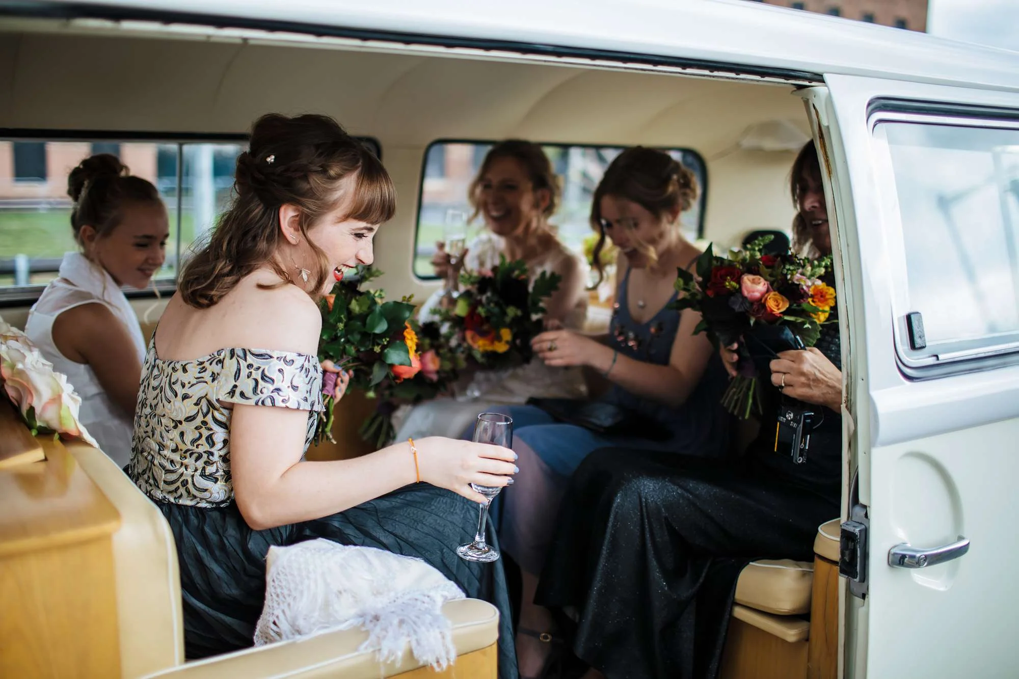 Bride and bridesmaids in a VW campervan