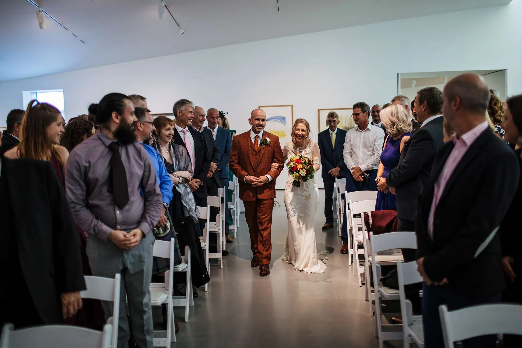 Bride and groom walk down the aisle at Hepworth Art Gallery