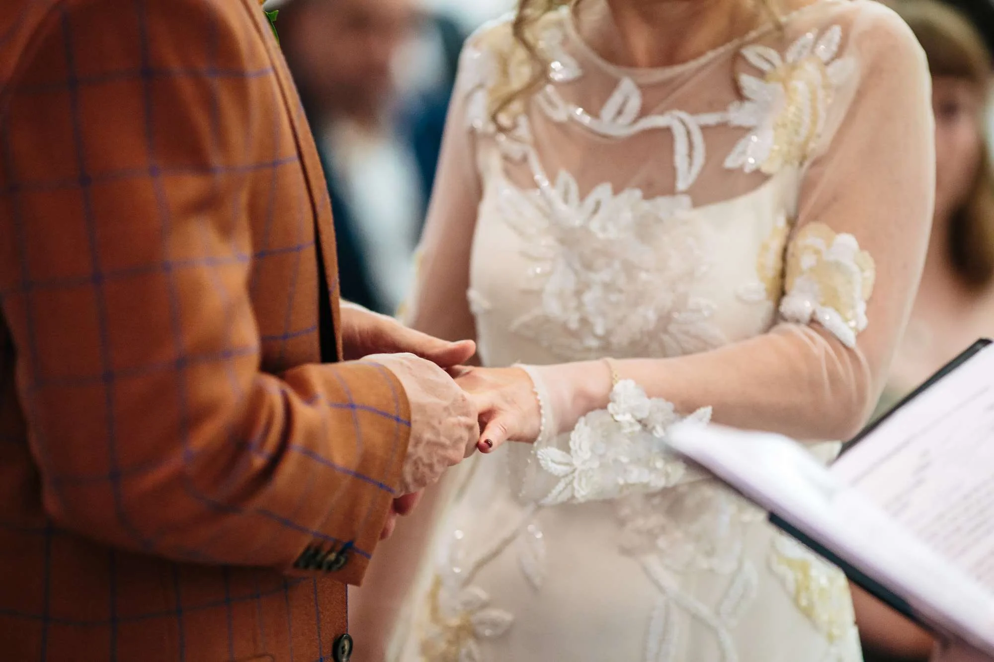 Bride and groom exchanging rings at a Wakefield wedding