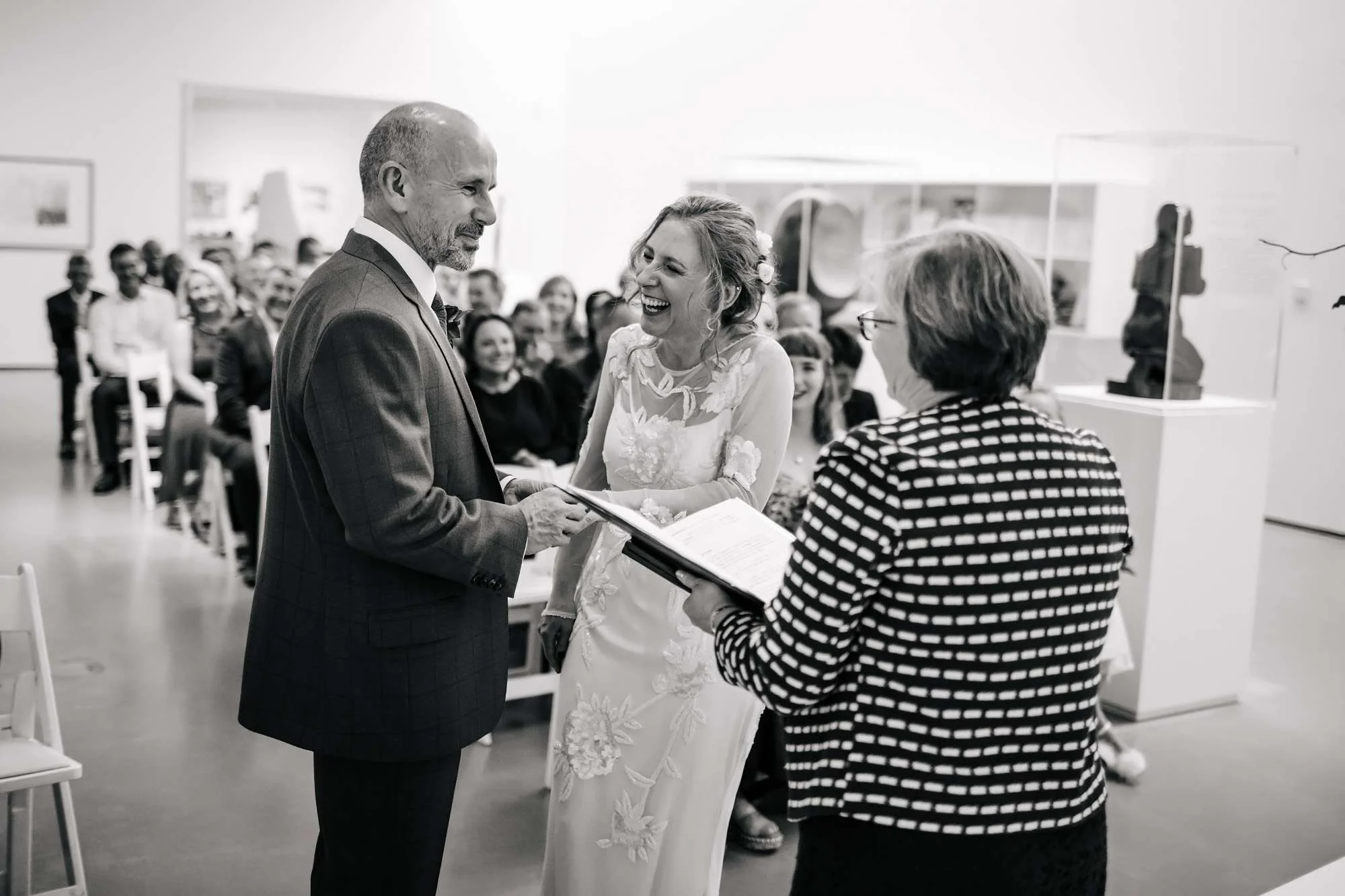 Bride and groom exchange rings at a Hepworth Art Gallery wedding