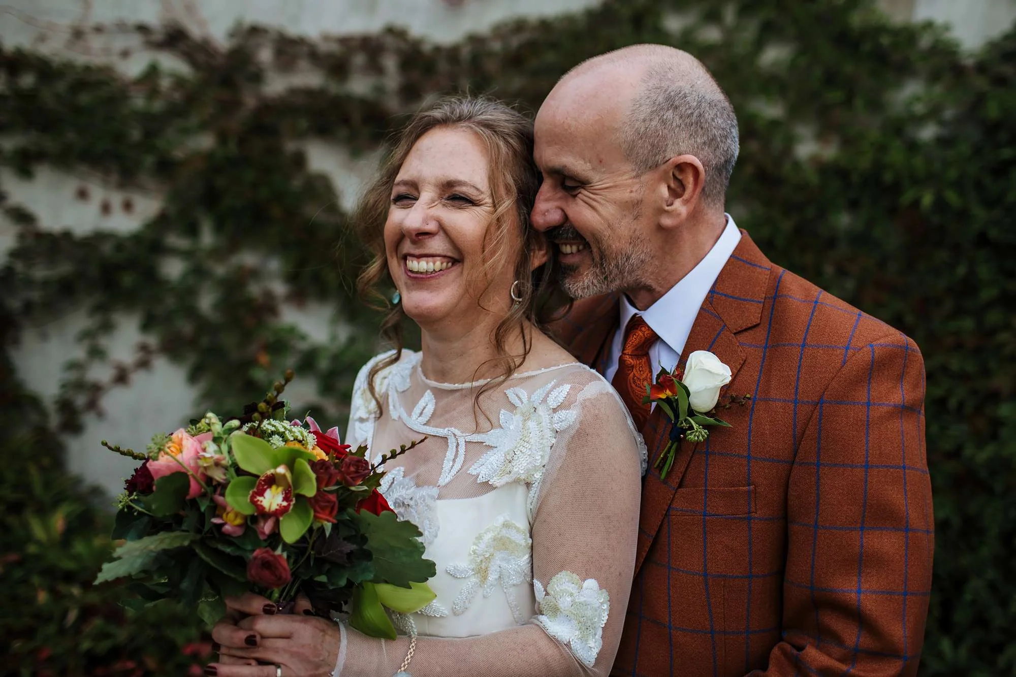 Bride and groom laughing on their wedding day at Hepworth Art Gallery