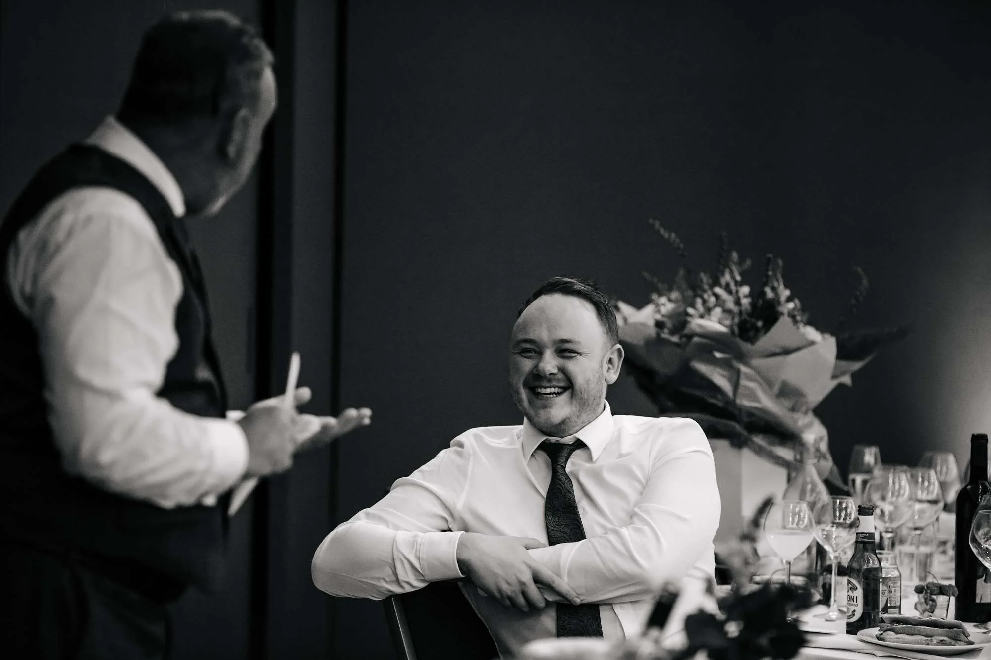 Wedding guests laughing during the speeches