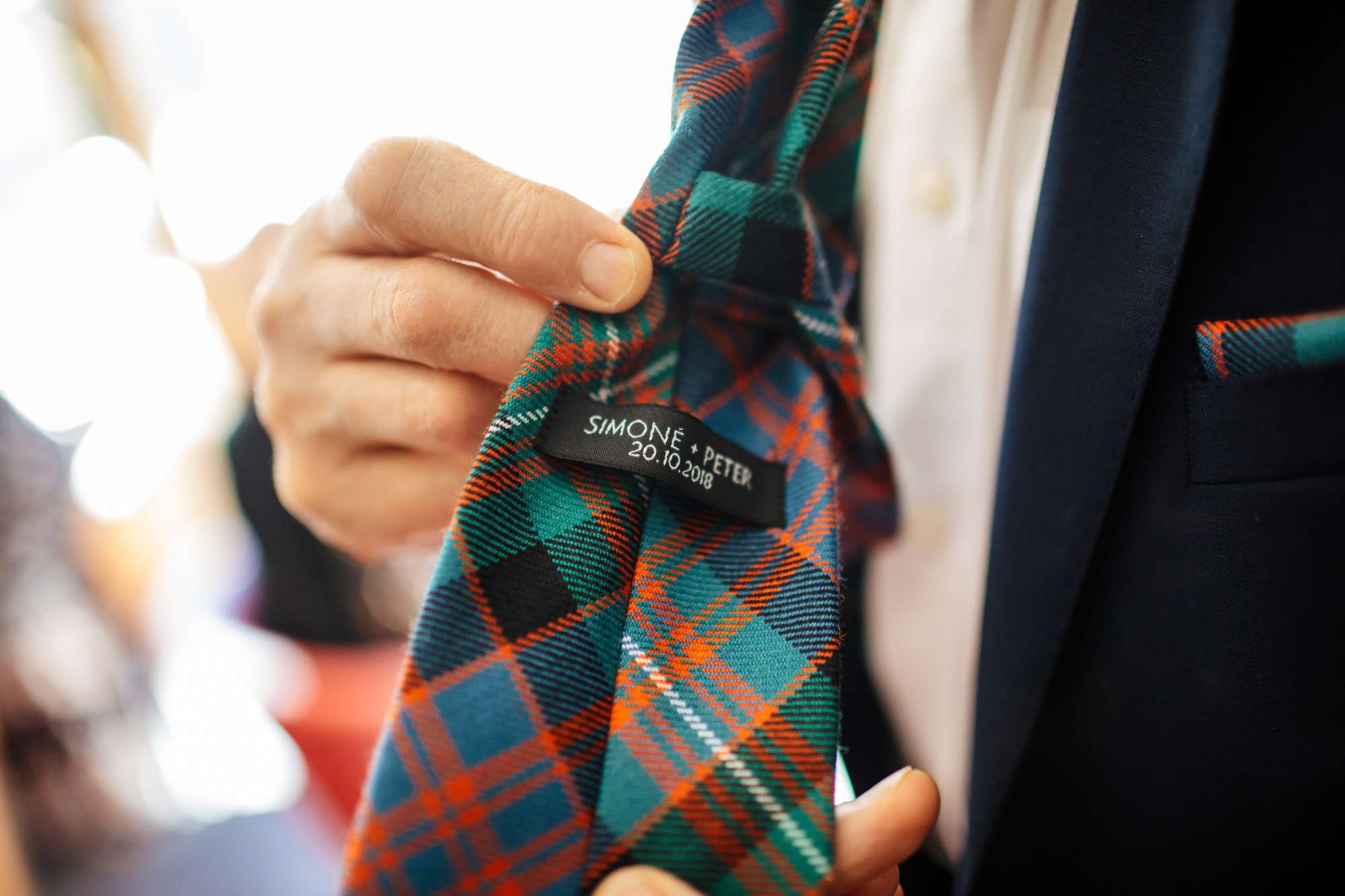 Groom has name and date embroidered on his tie