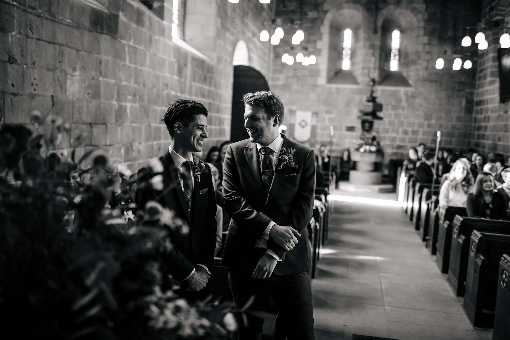 Groom and best man joking in the church