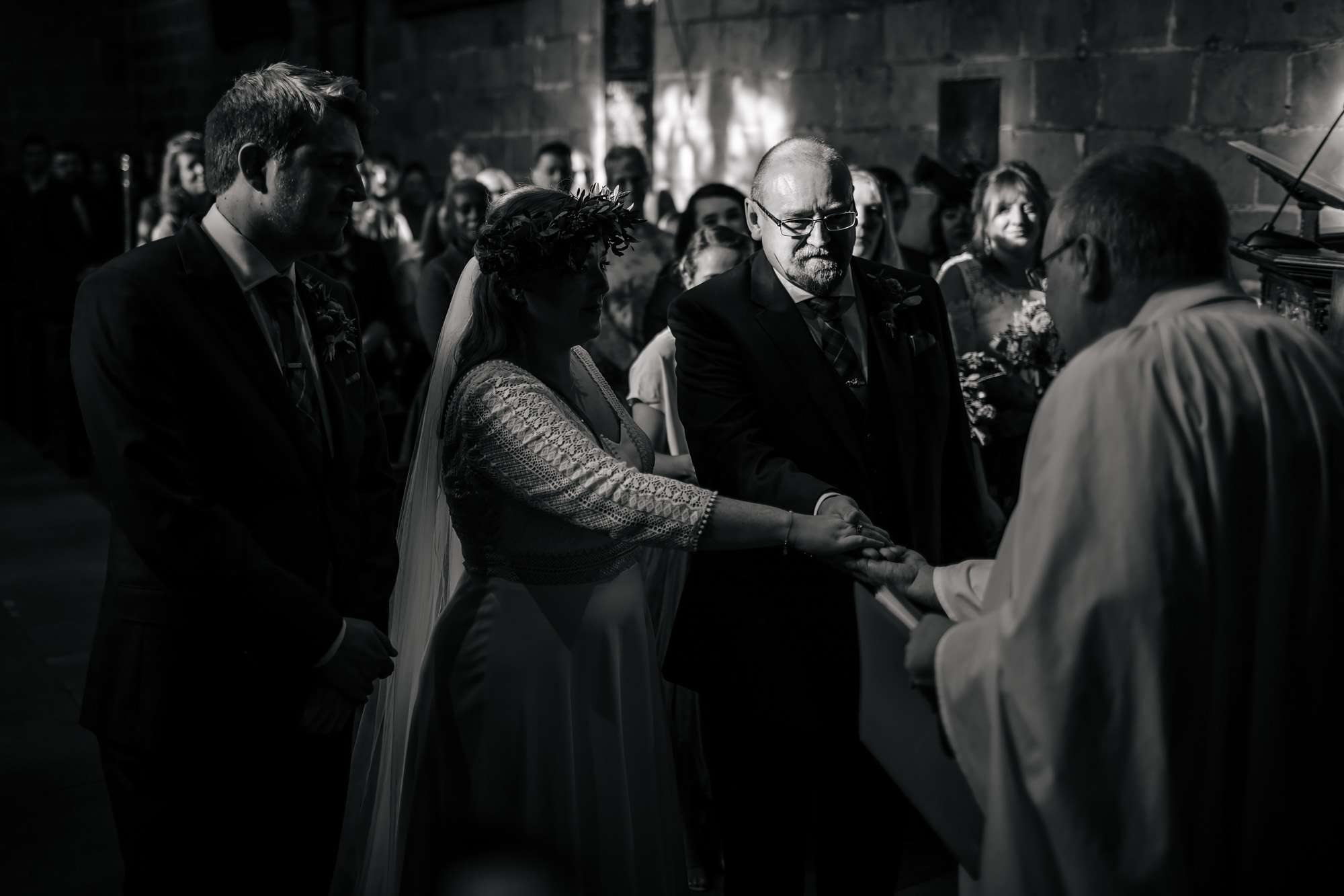 Bride and father holding hands on her wedding day