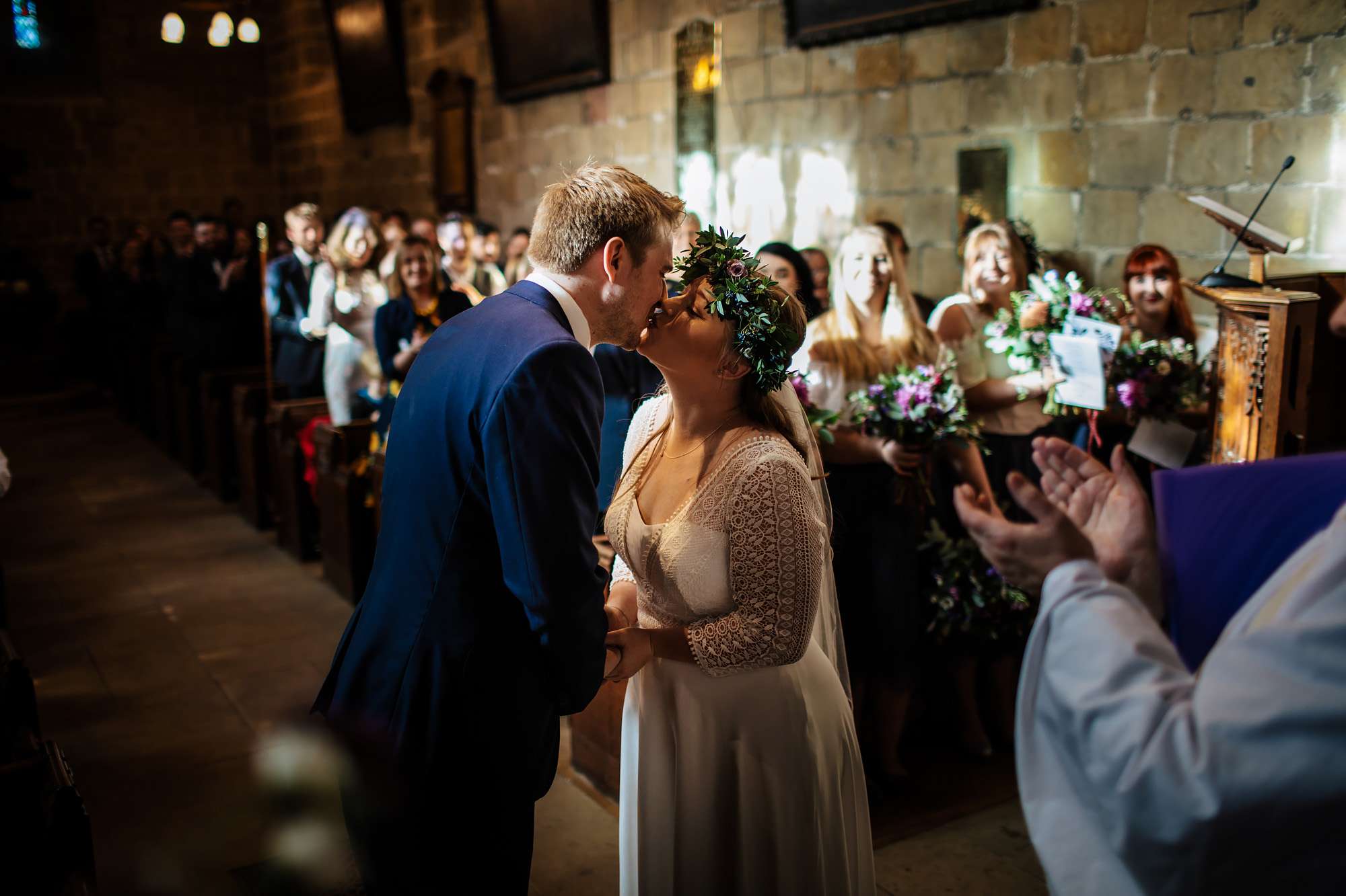 Bride and groom kiss during their wedding ceremony