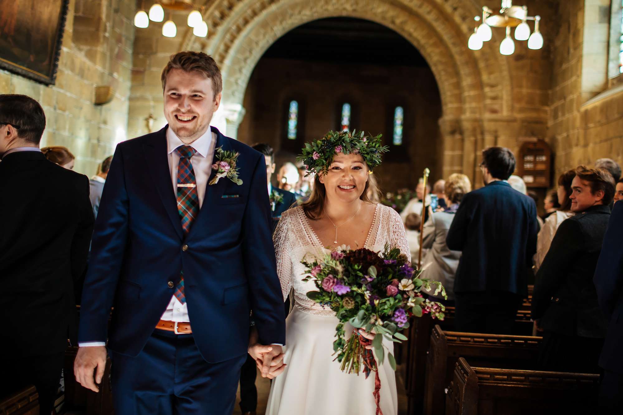 Bride and groom walking down the aisle in Leeds