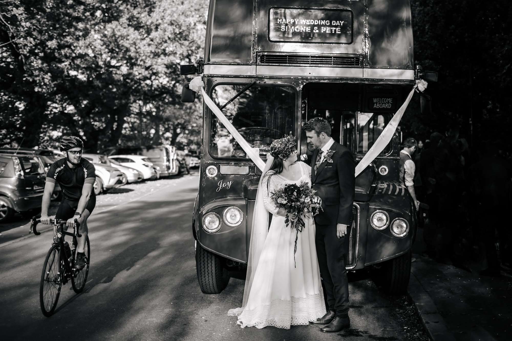Bride and groom pose in front of their Leeds wedding bus