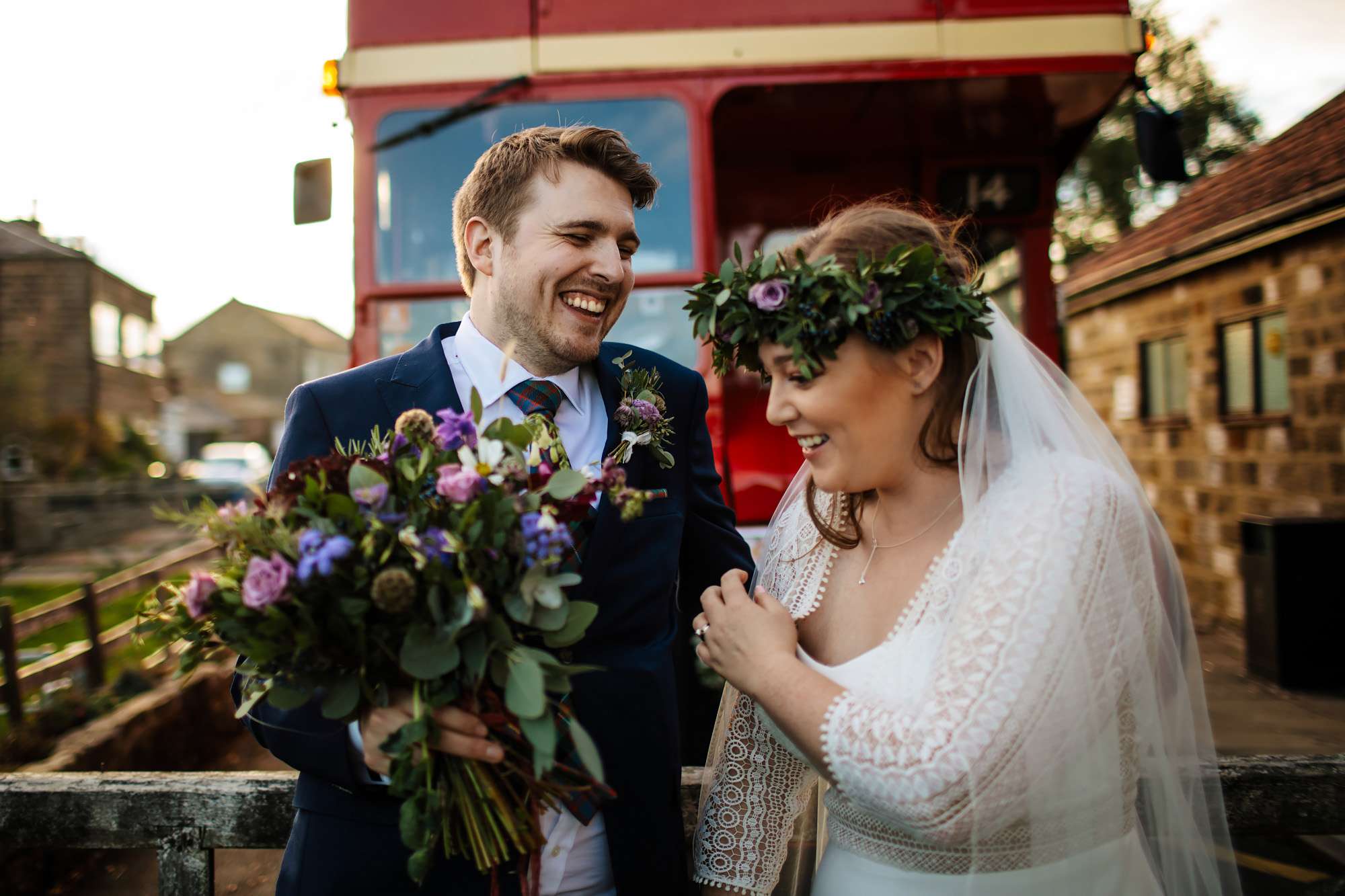 Bride and groom in front of their vintage wedding bus