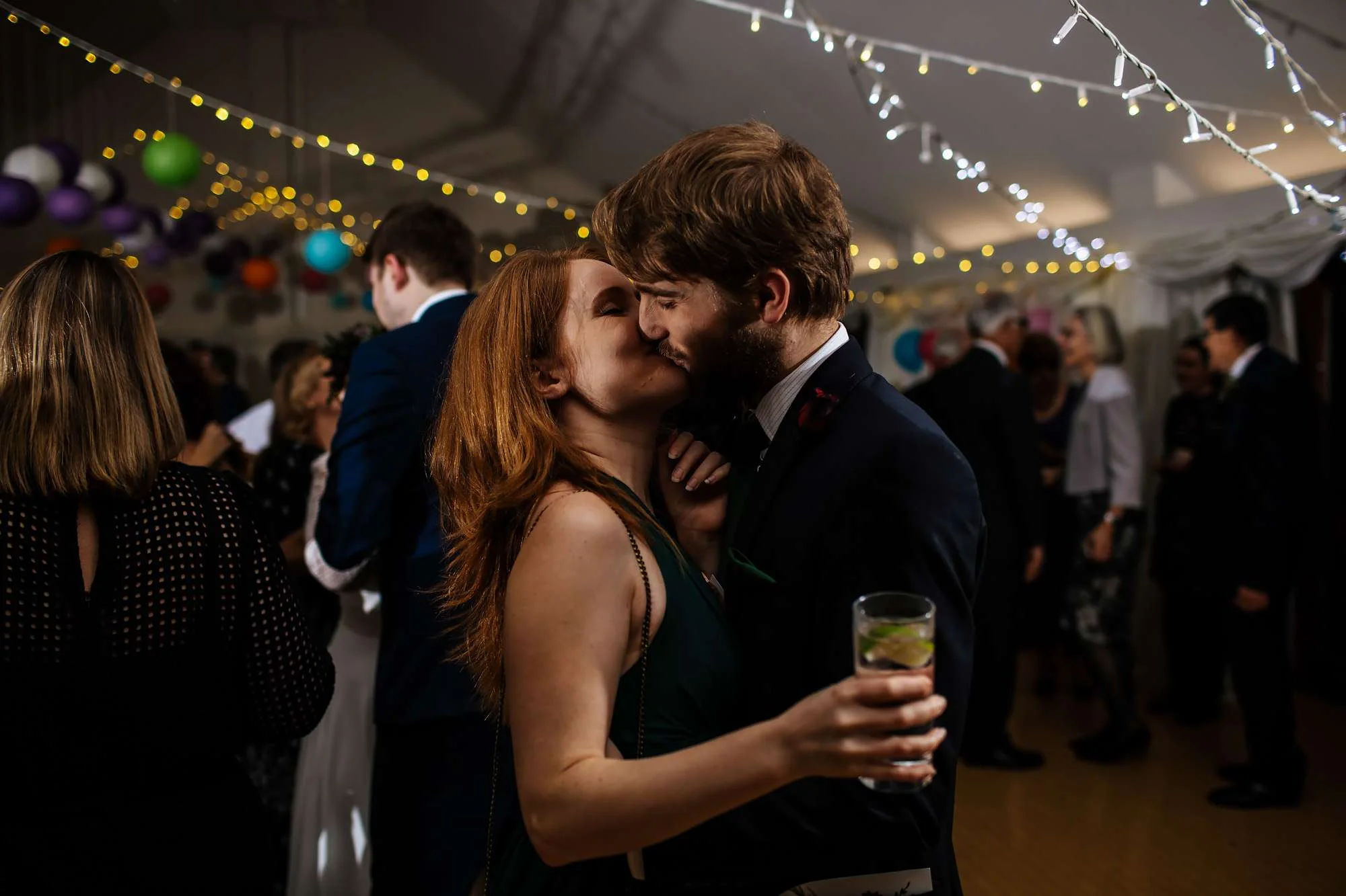 Wedding guests kissing at East Keswick Village Hall Leeds