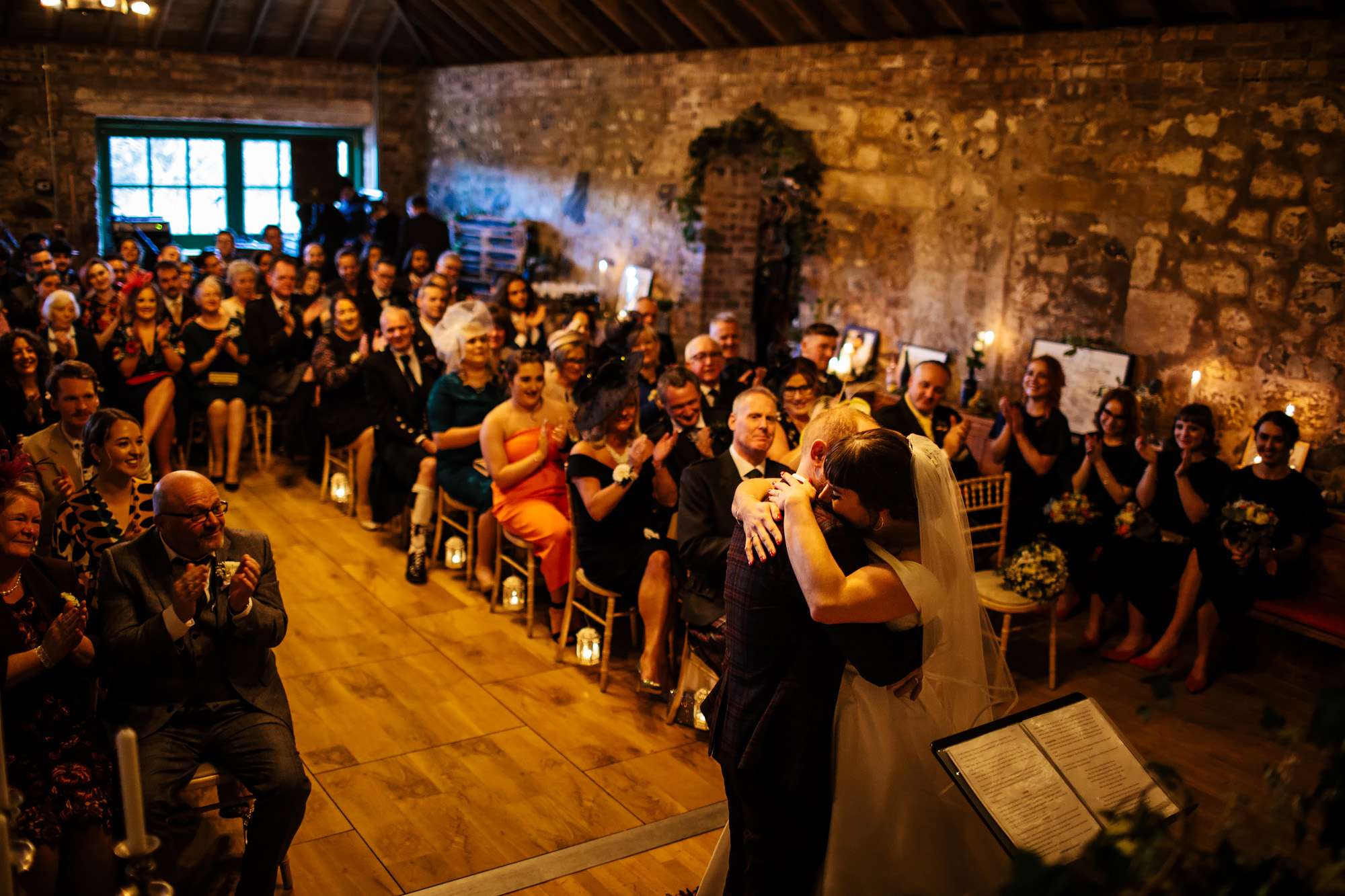 Bride and groom hug during their wedding ceremony in Scotland