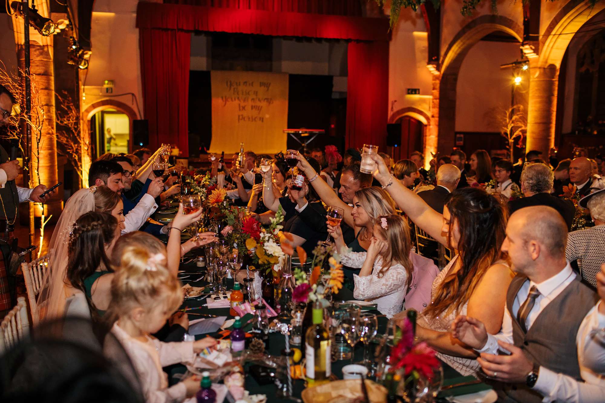 Wedding guests raising a toast at Scottish wedding