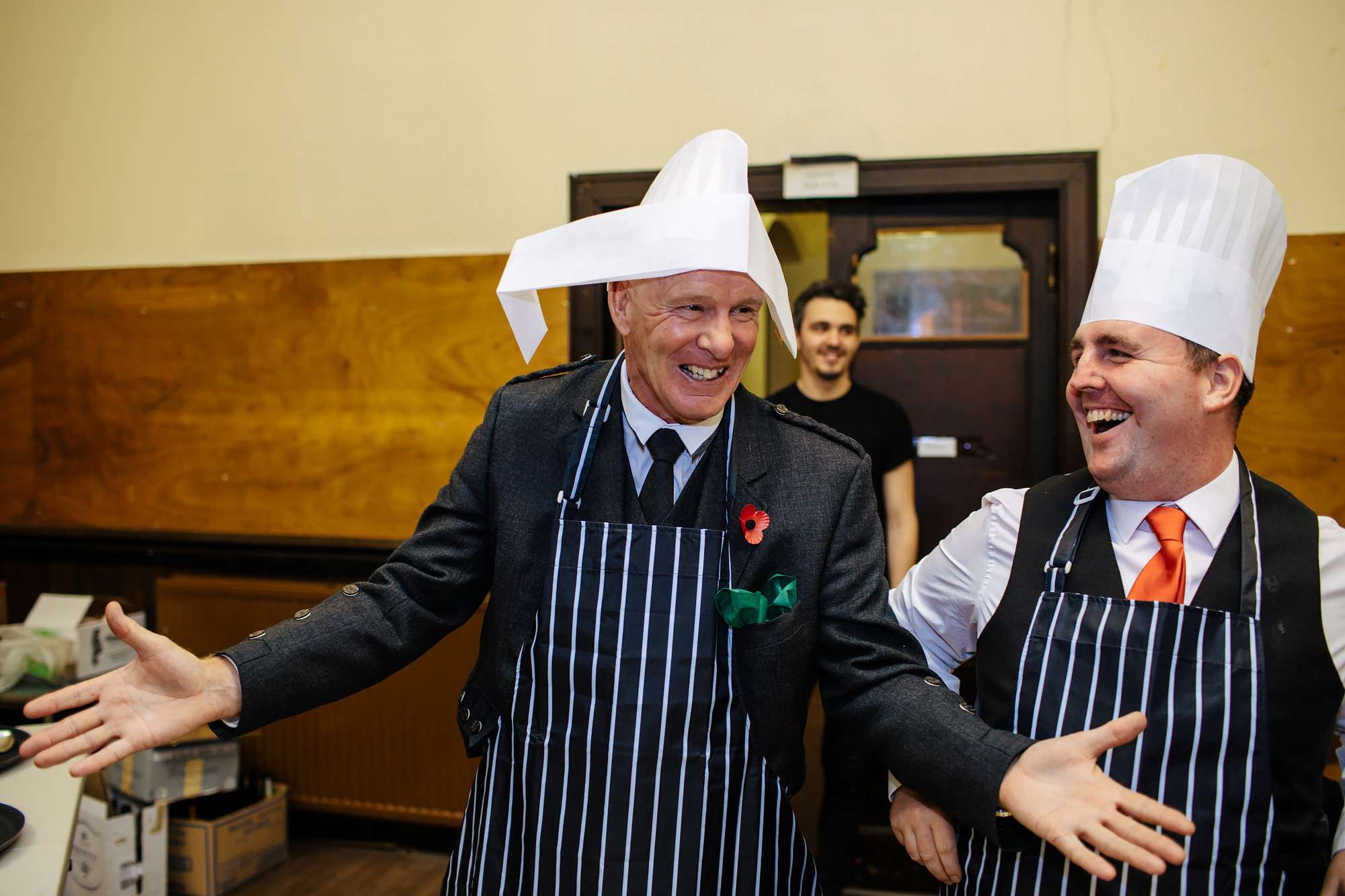 Wedding guests joking in chefs hats