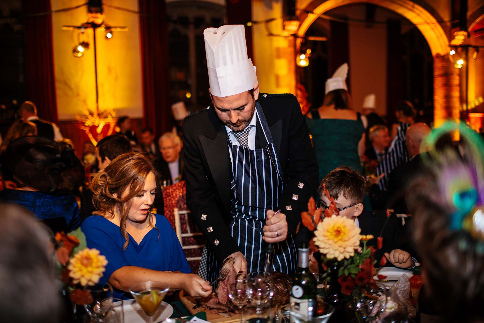 Wedding guests carving meat in Crail