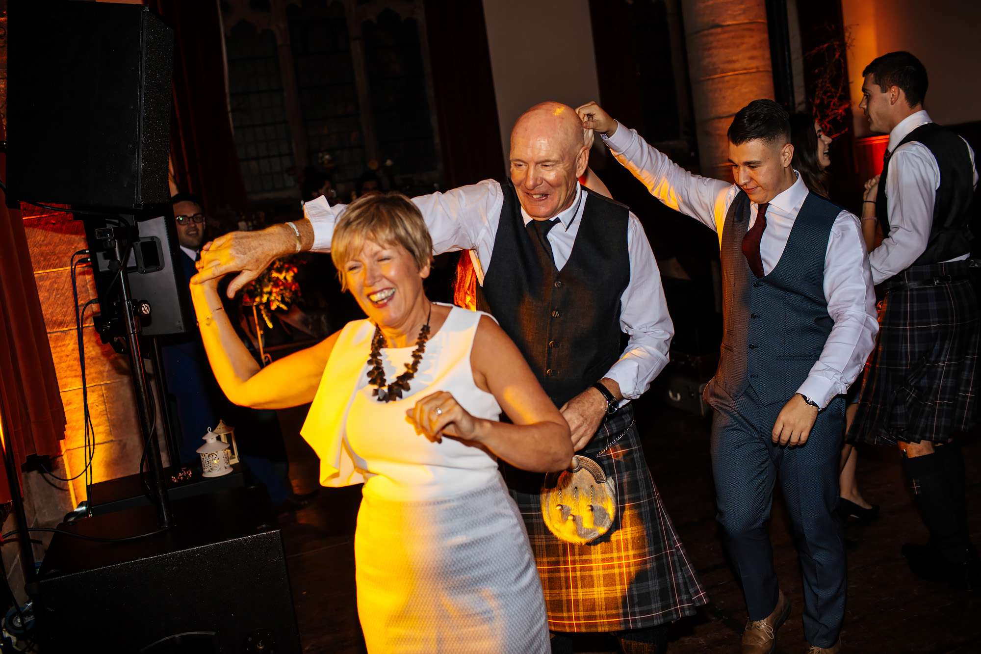 Wedding guests ceilidh dancing in Crail