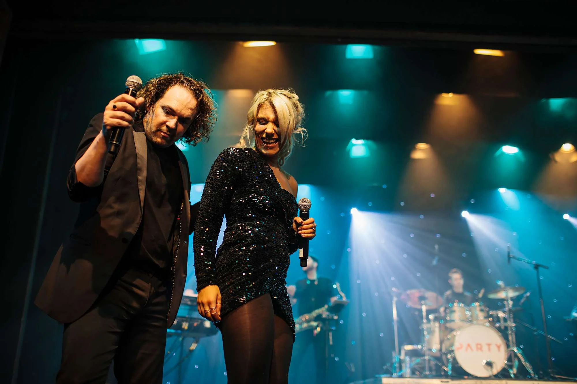 Singers performing on stage at a wedding