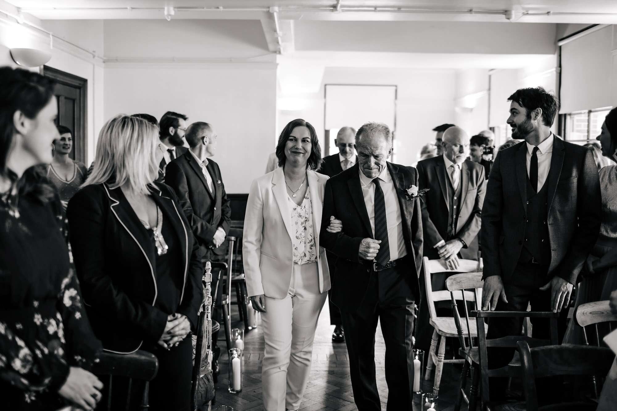 Bride and dad walk down the aisle at a wedding