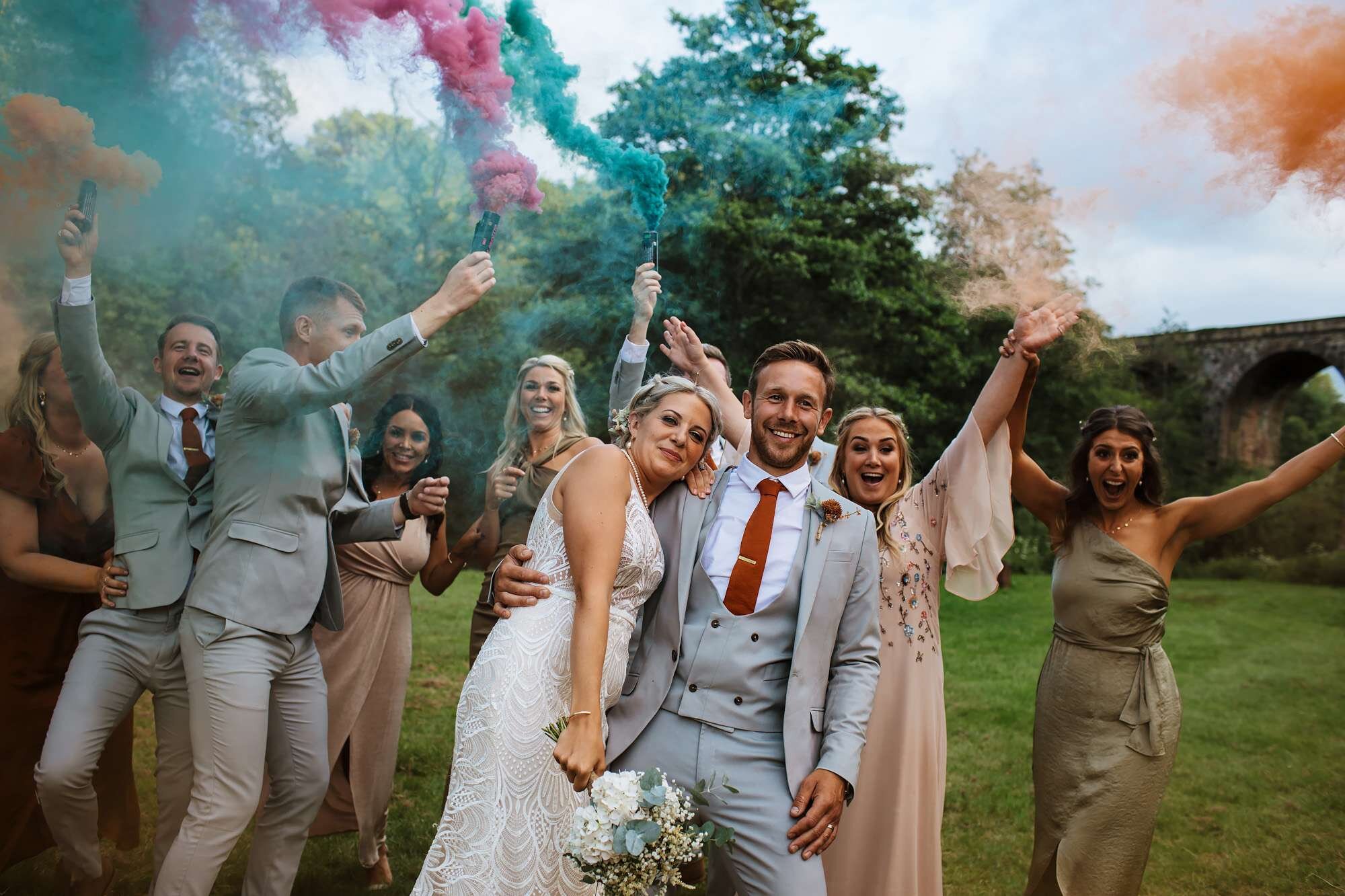 Bridal party with smoke bombs at a wedding