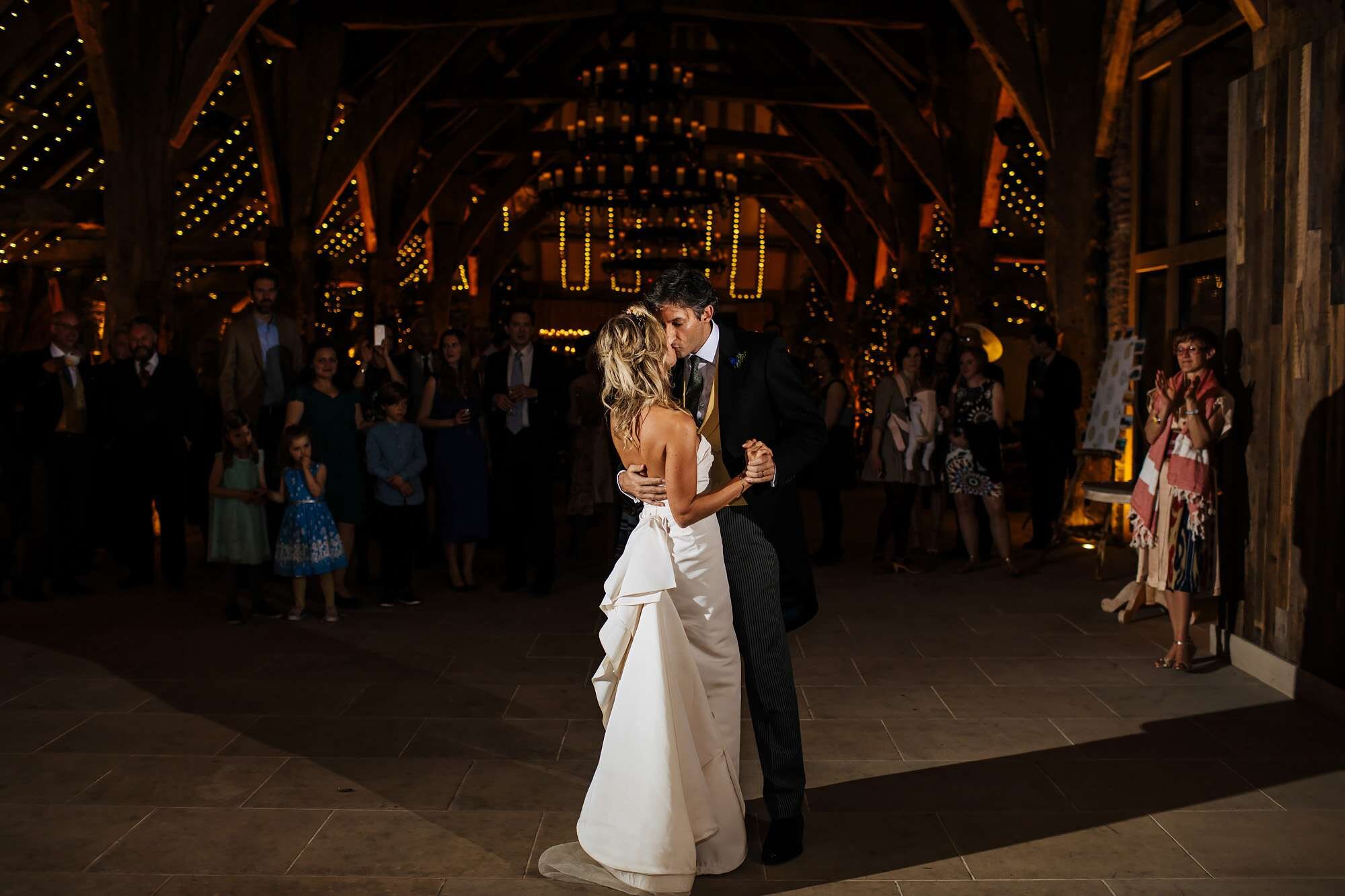 Bride and groom kiss on the dance floor at the wedding