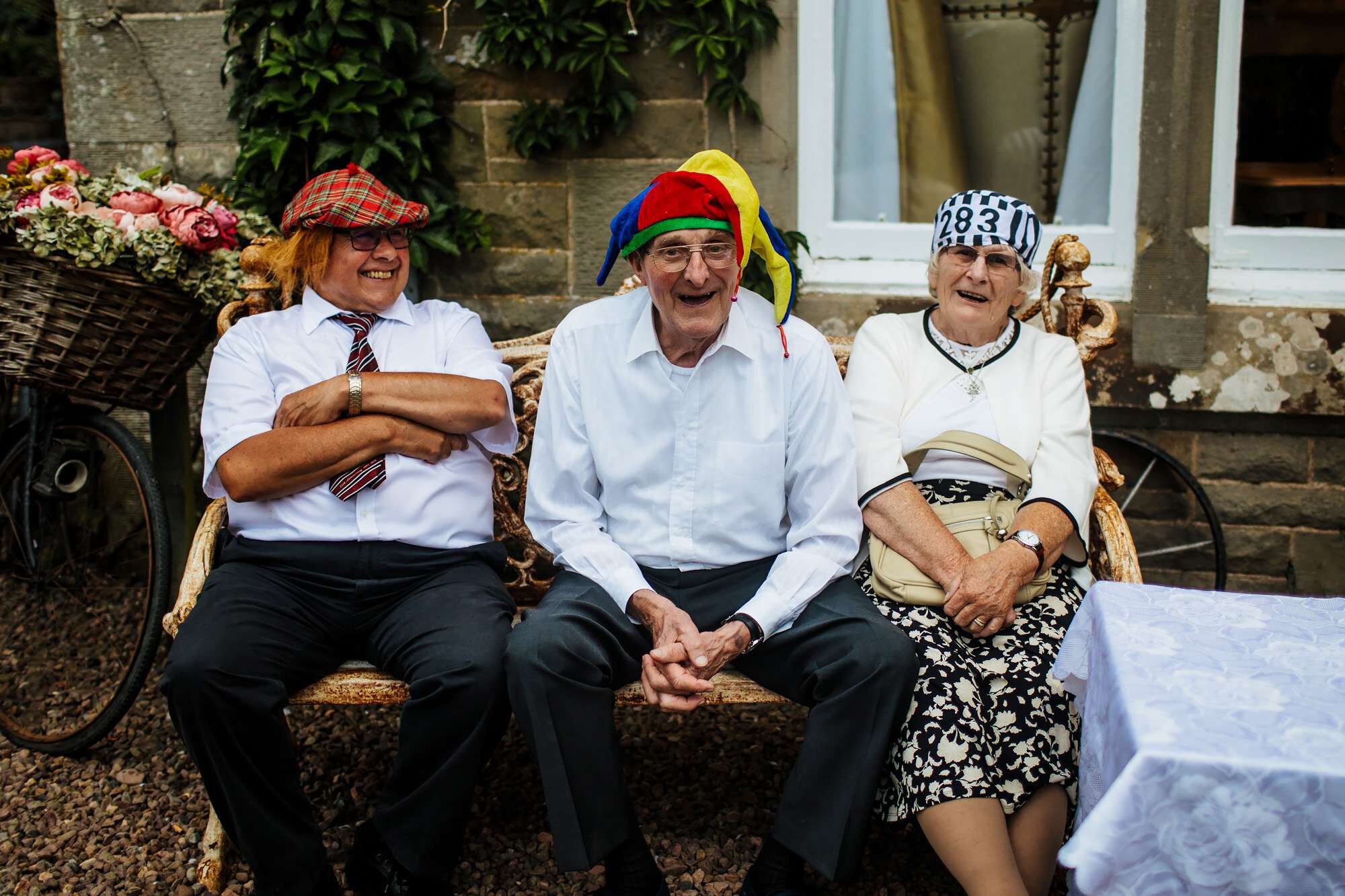 Pensioners in funny hats at a wedding