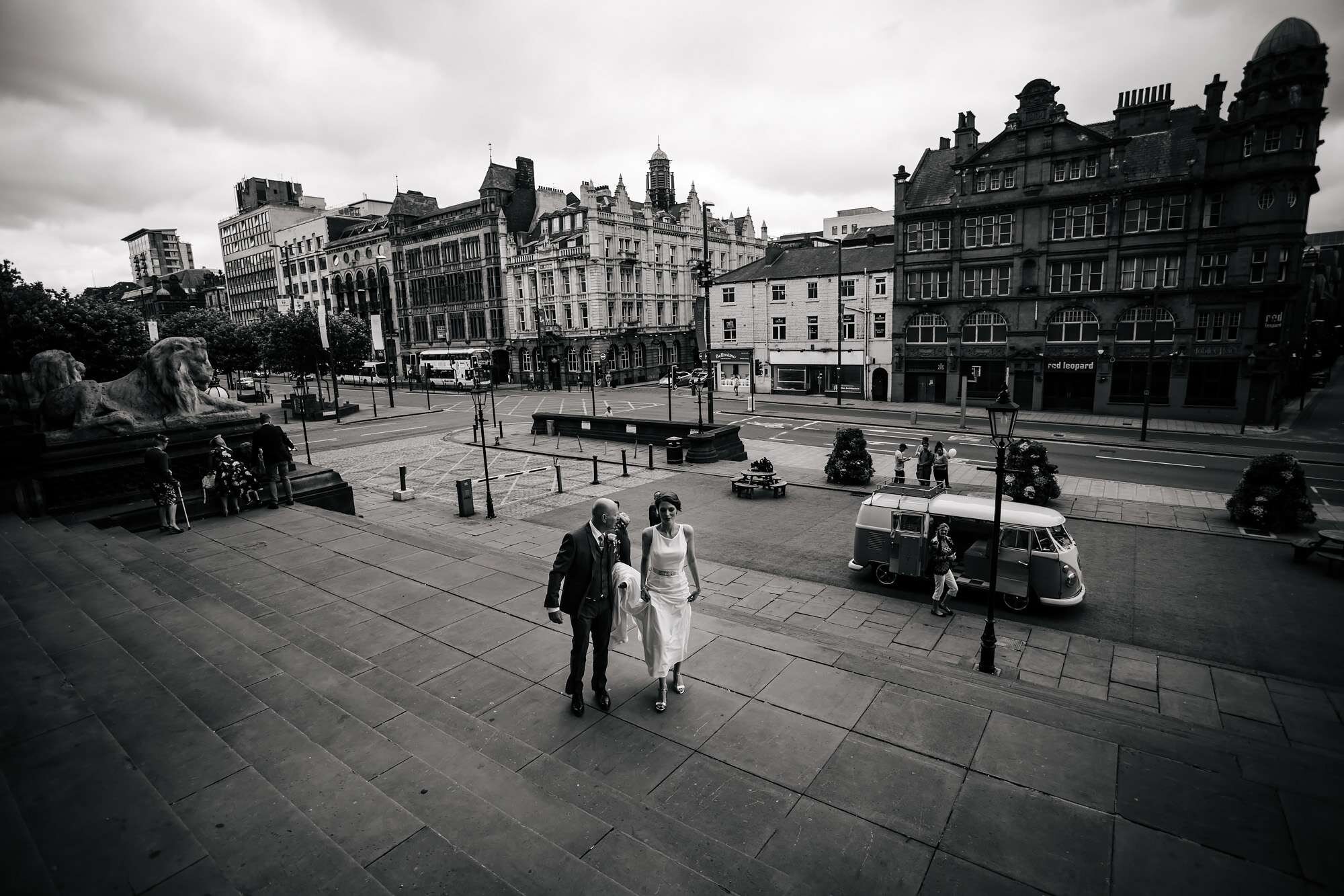 Bride and dad walk to a Leeds Town Hall wedding