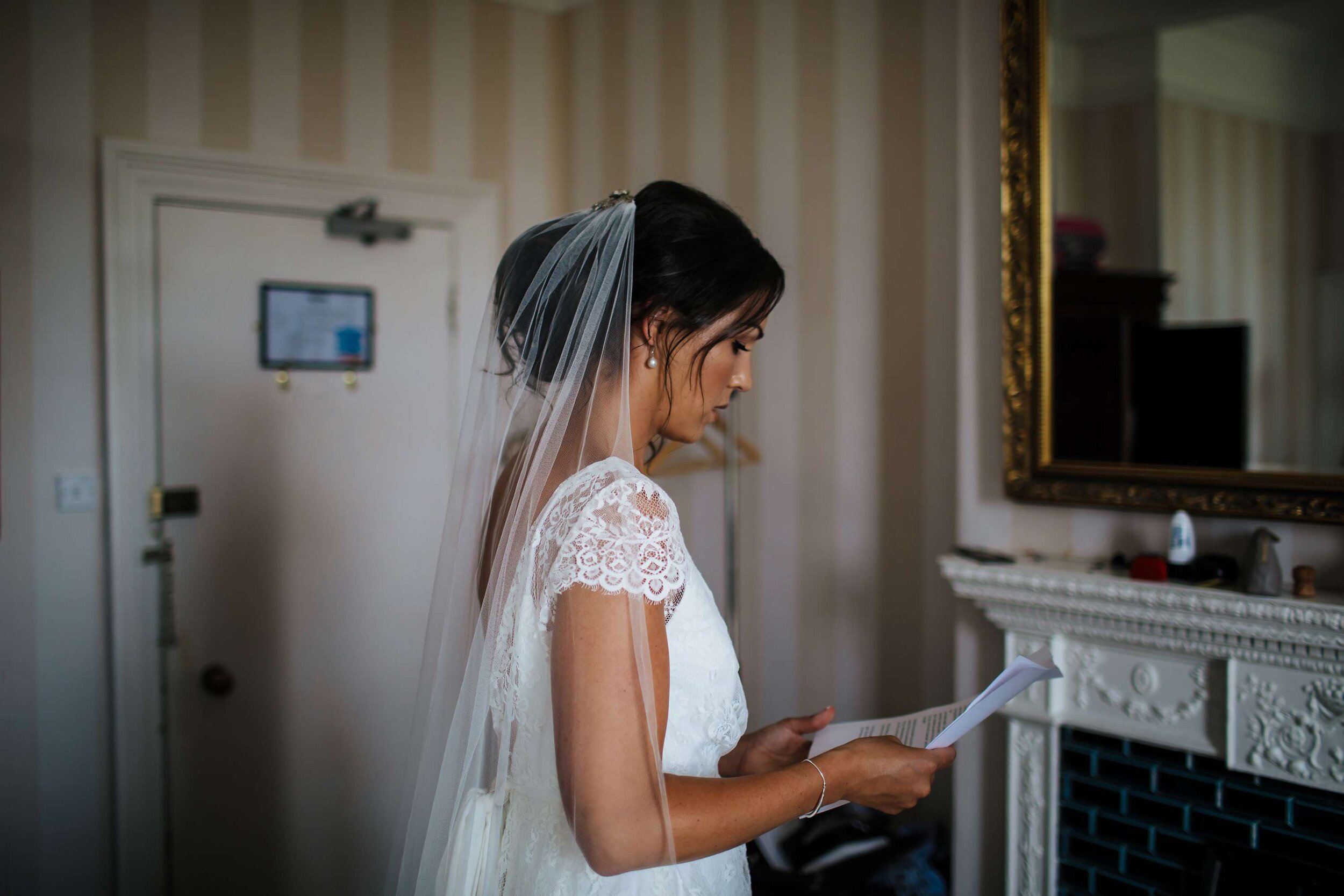Bride practising her speech for her wedding in her dress