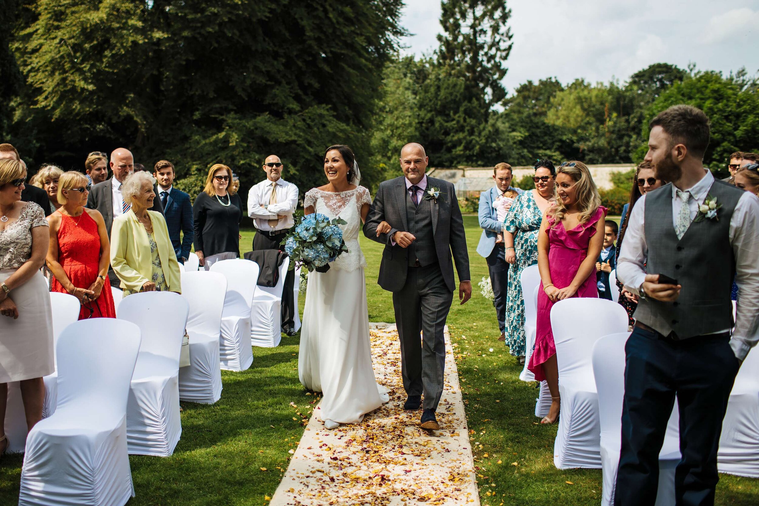 Bride and dad walk down the aisle at a Solberge Hall wedding