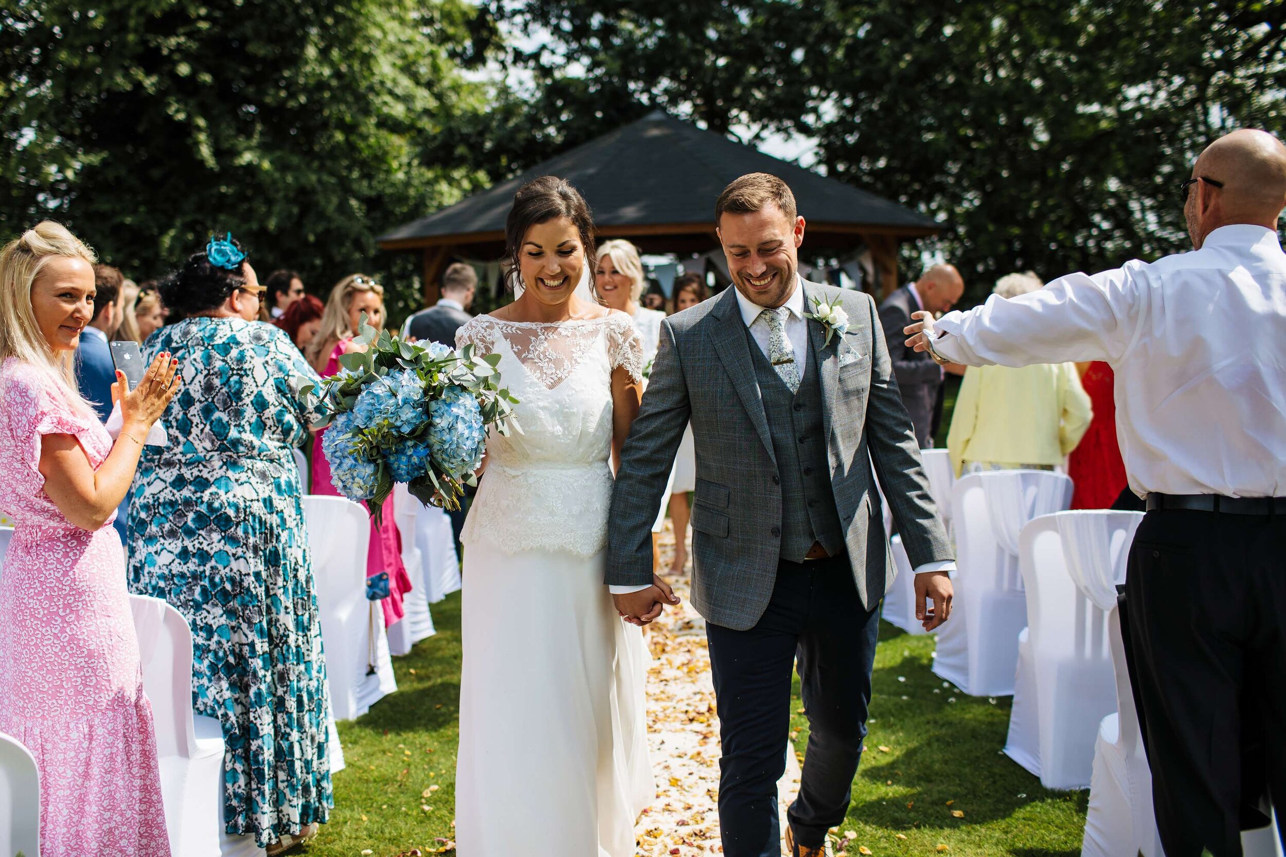Bride and groom walk down the aisle at a Solberge Hall wedding