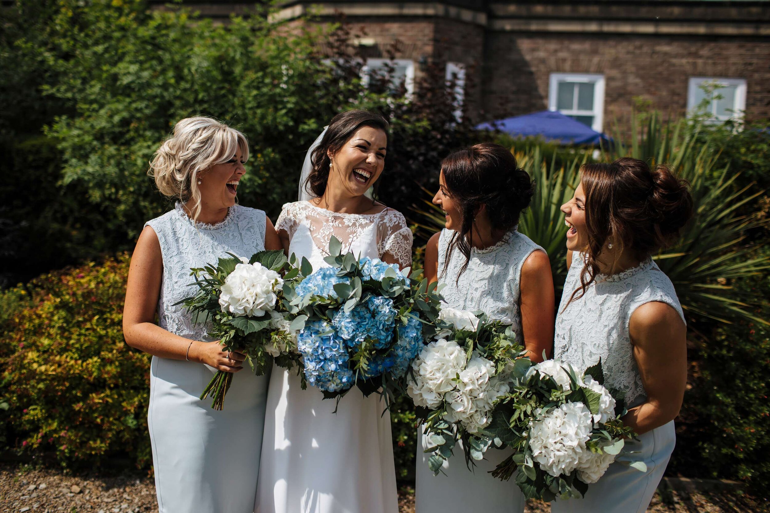 Bride and her bridesmaids laughing at a Yorkshire wedding