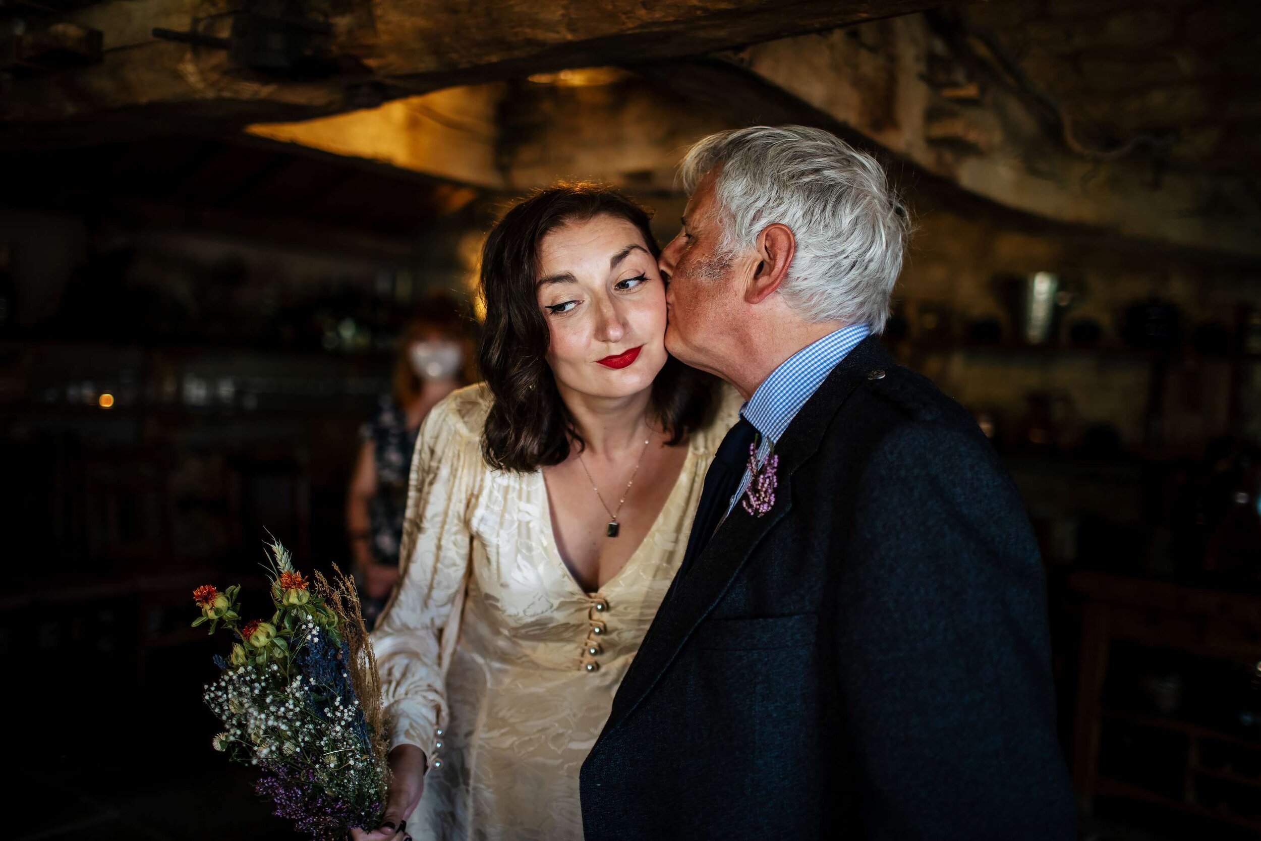 Bride and dad kiss at a North Yorkshire wedding