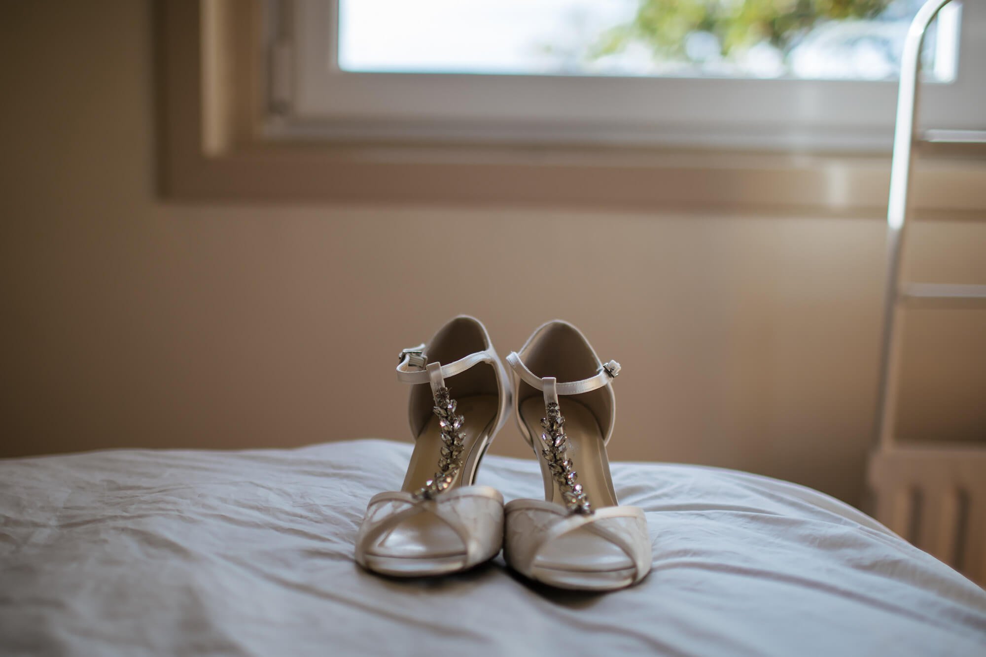 Wedding shoes placed on the bed