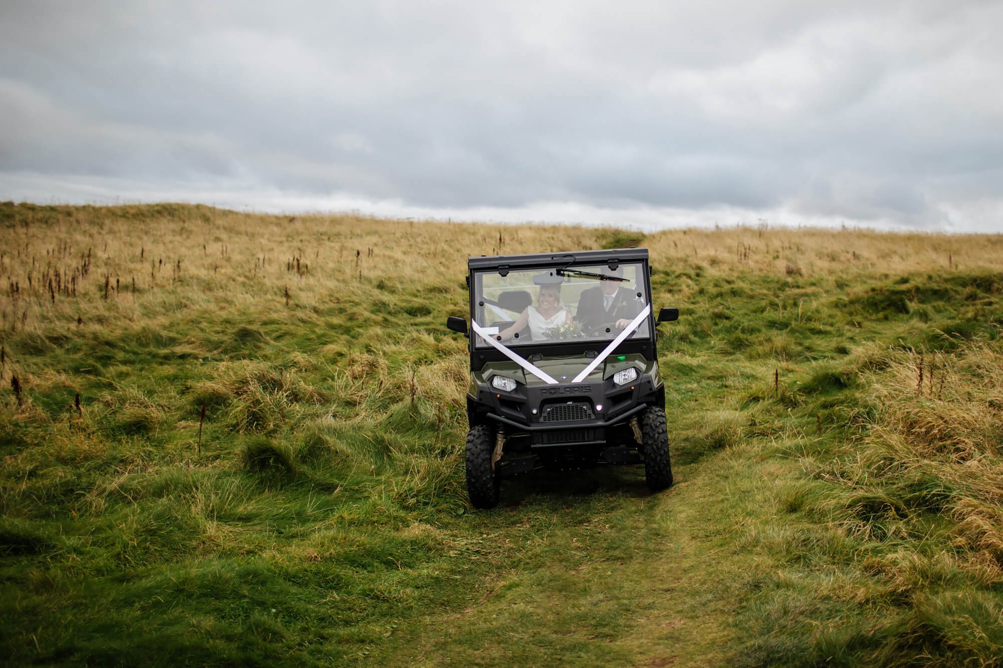 Bride and groom arrive in an off road vehicle in Scotland