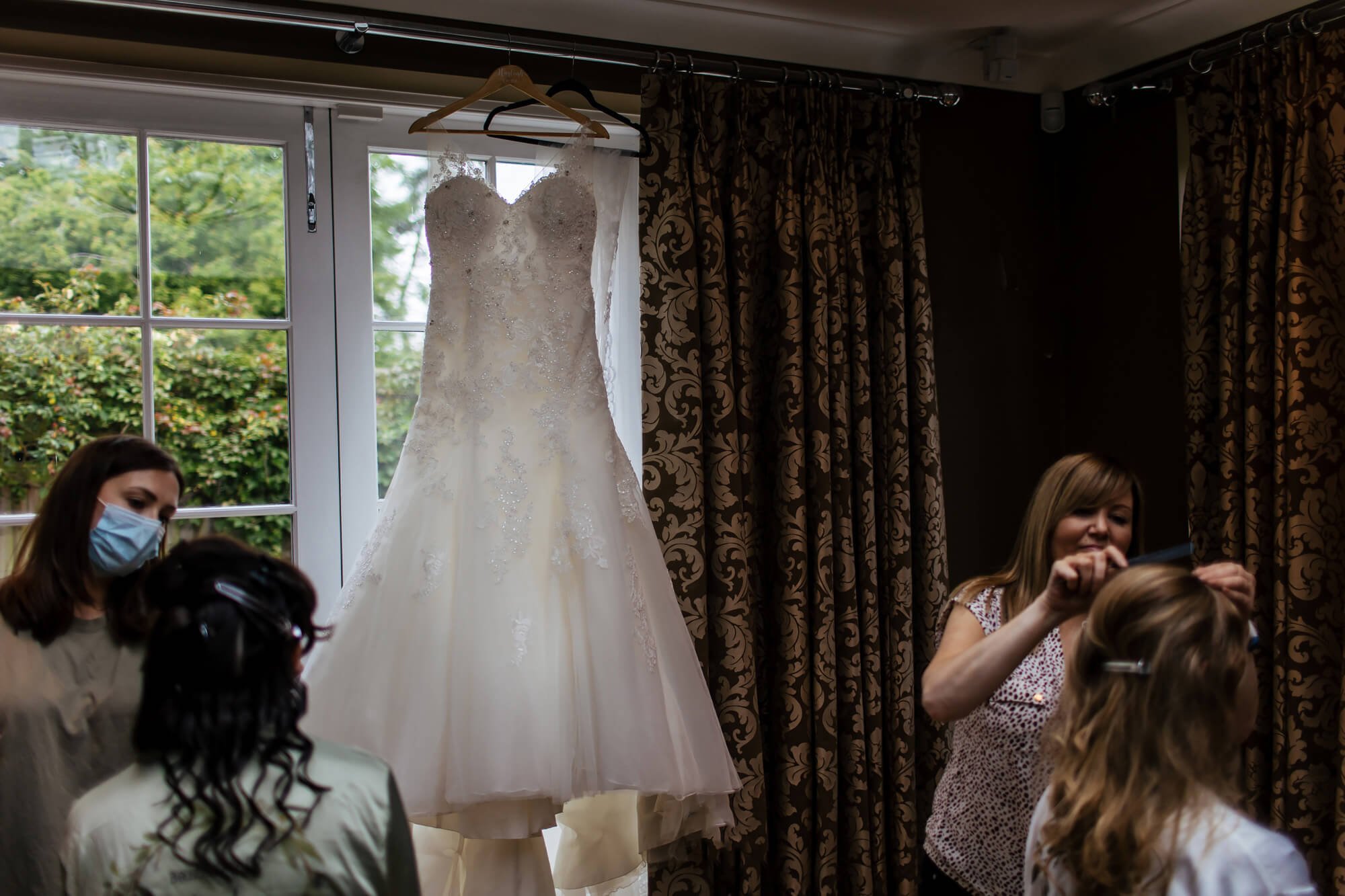 Wedding dress hanging up in the window