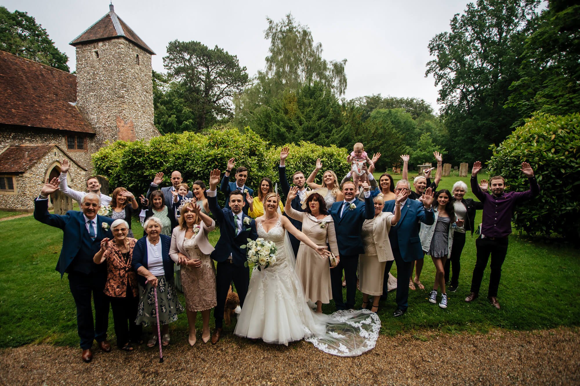 Group photo of the wedding guests at a church