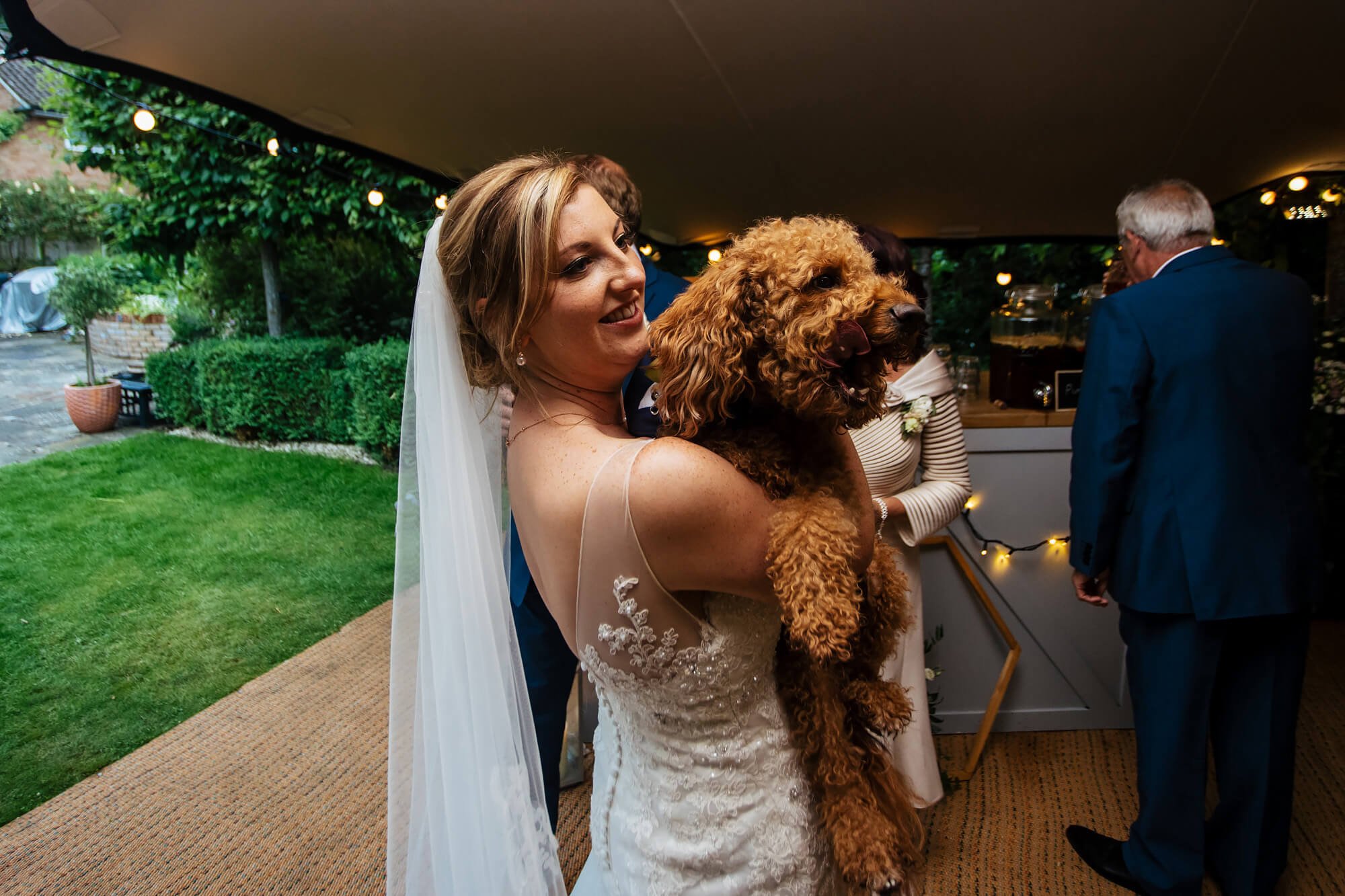 Bride holds her dog on the wedding day