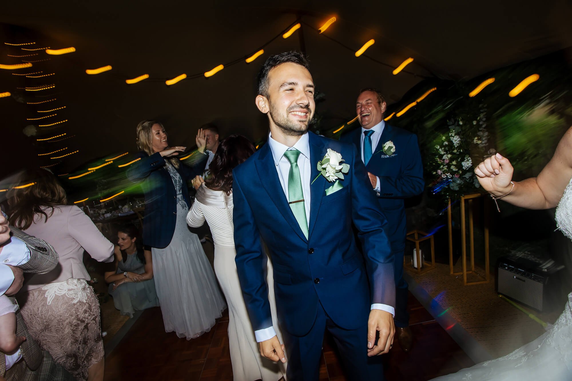 Groom smiling on the dance floor at his wedding