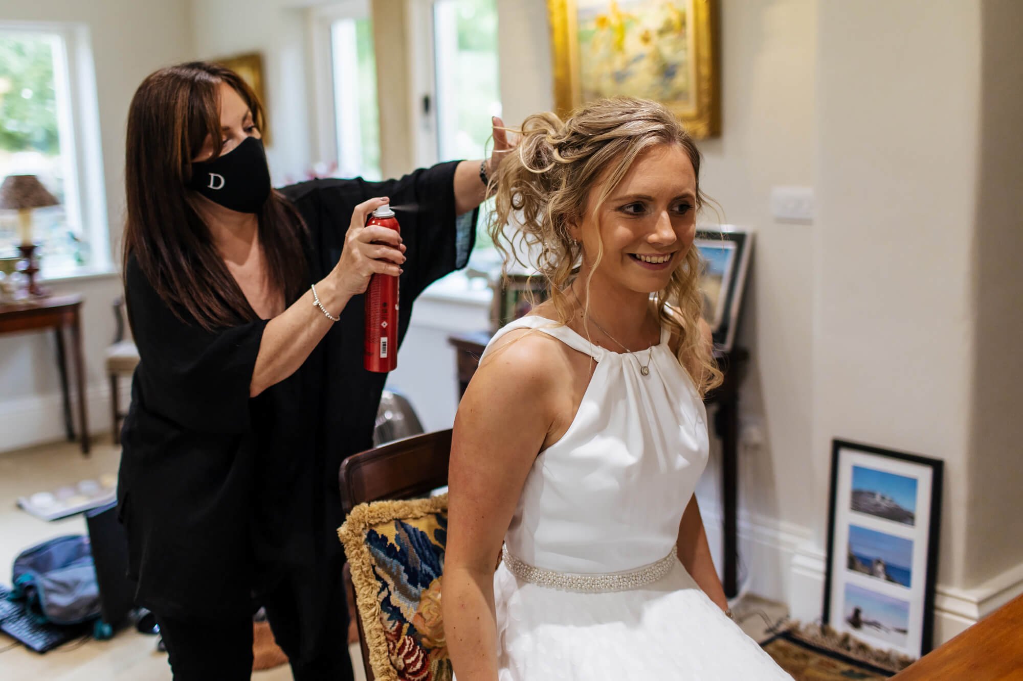Bride having her hair sprayed for her wedding