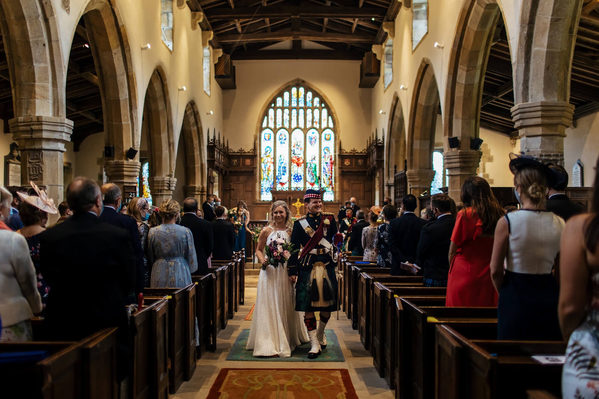 Bride and groom walking down the aisle at their wedding