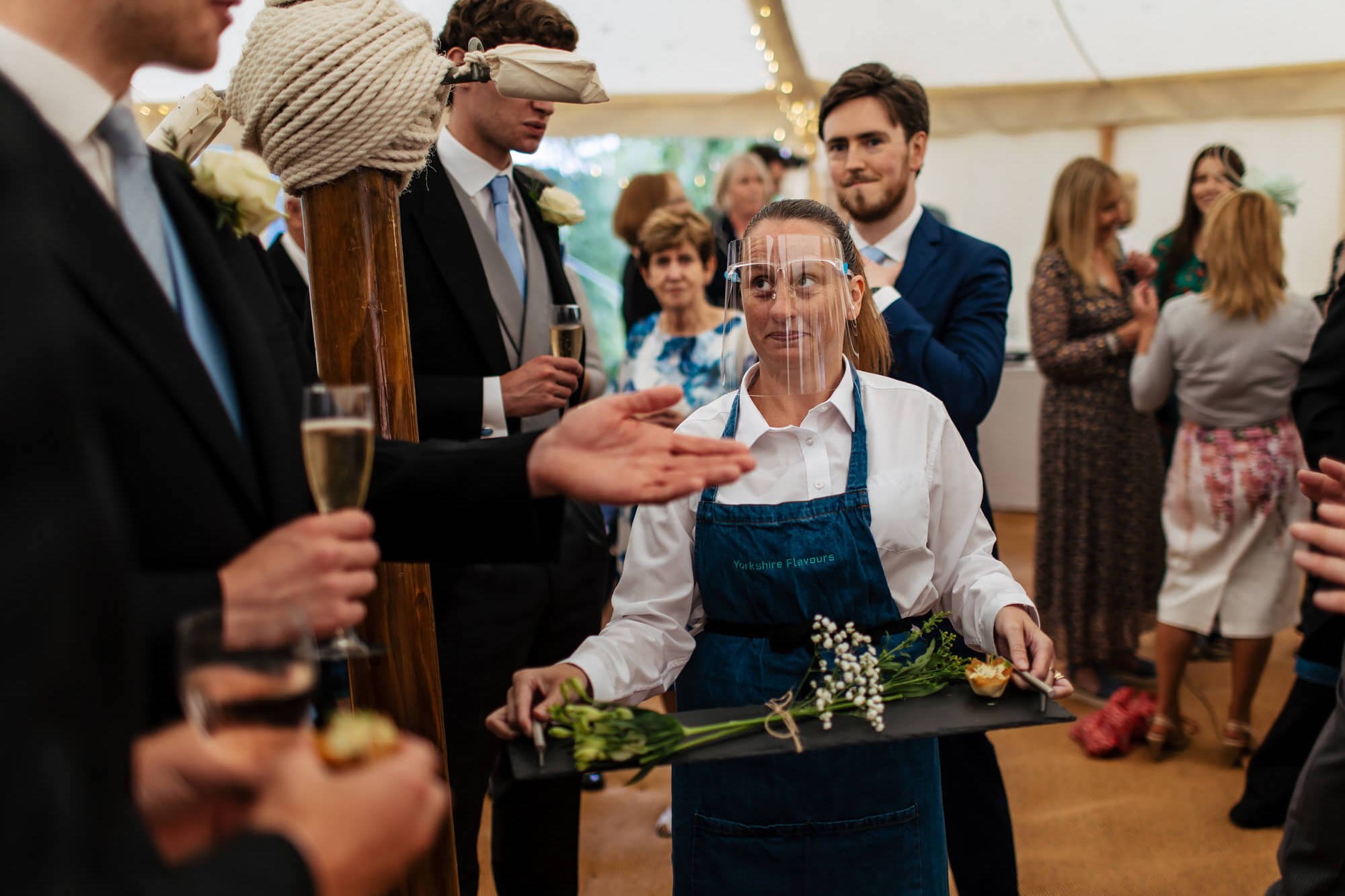 Waitress serving the canapés to wedding guests