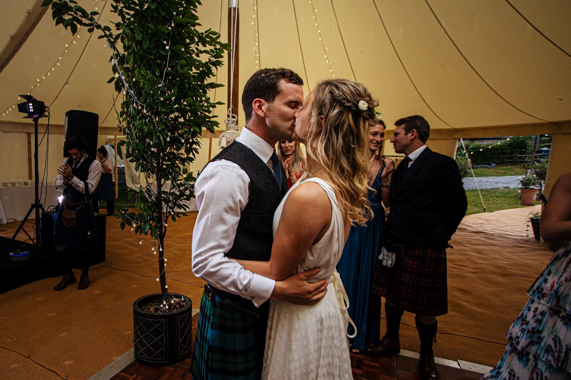 Bride and groom kissing on the dance floor 