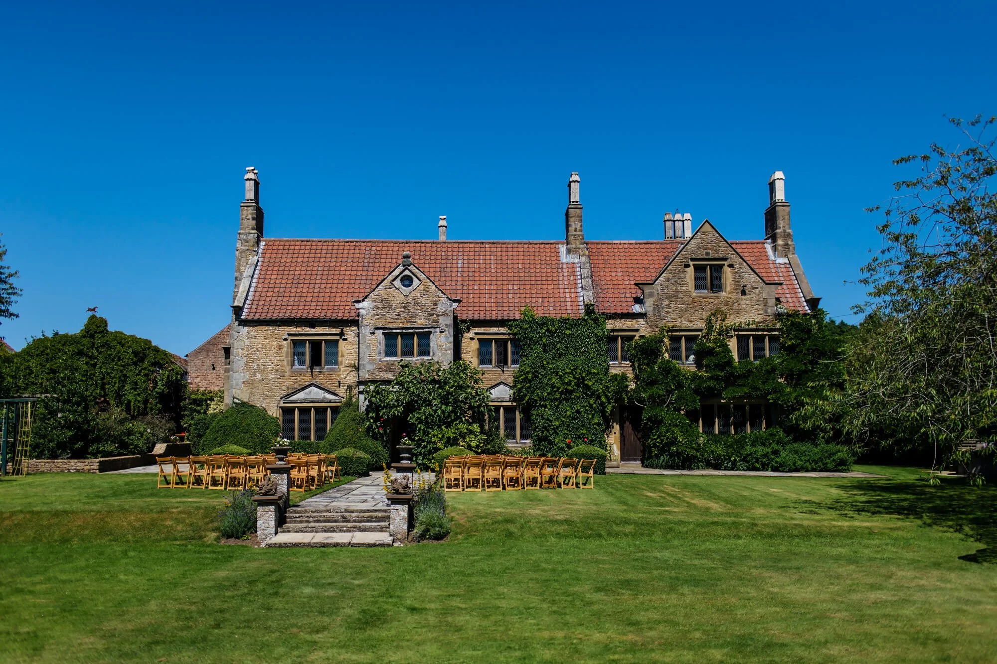 Crayke Manor in the sunshine against a blue sky