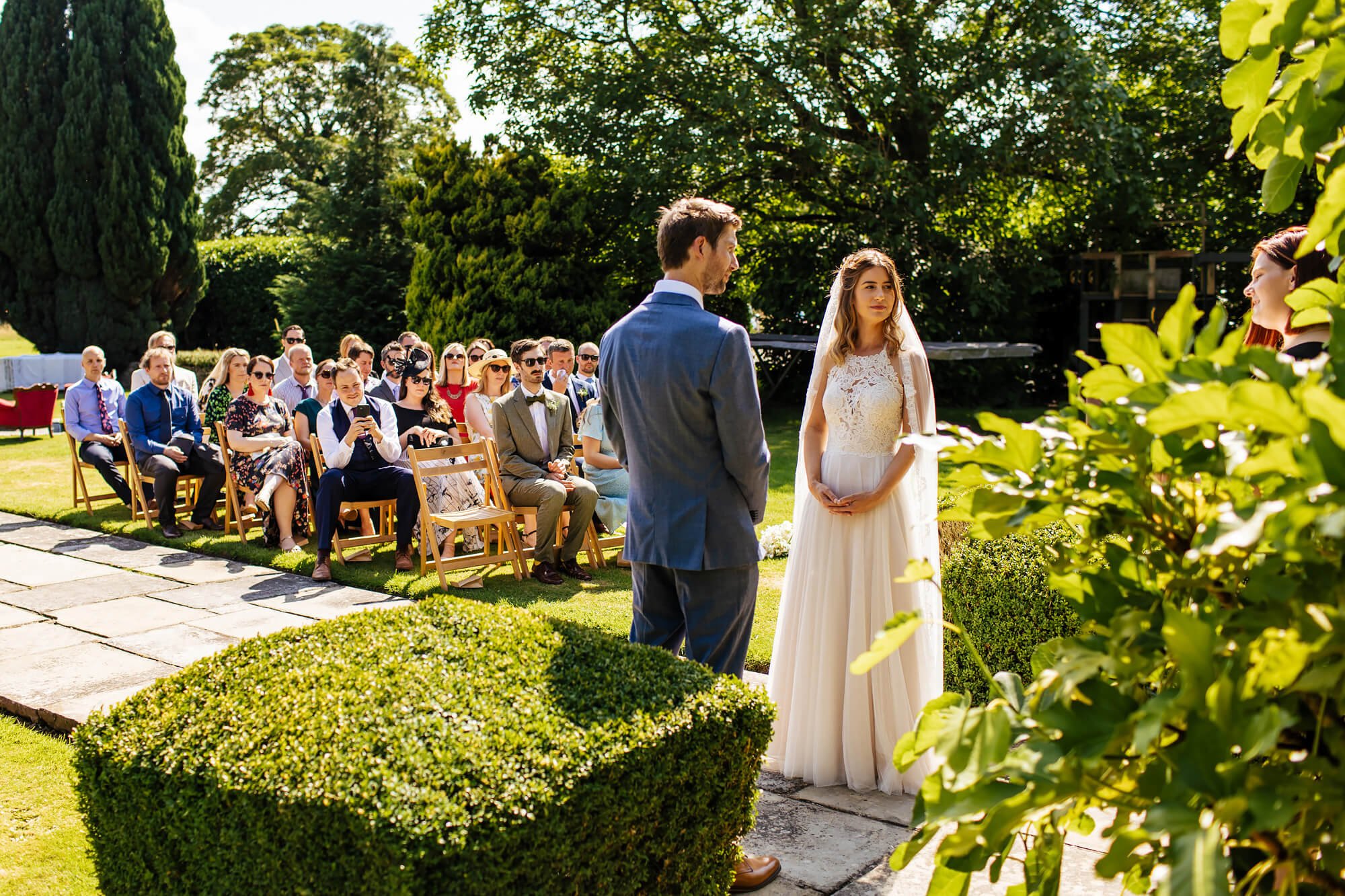 Wedding guests sitting in the sunshine at Crayke Manor