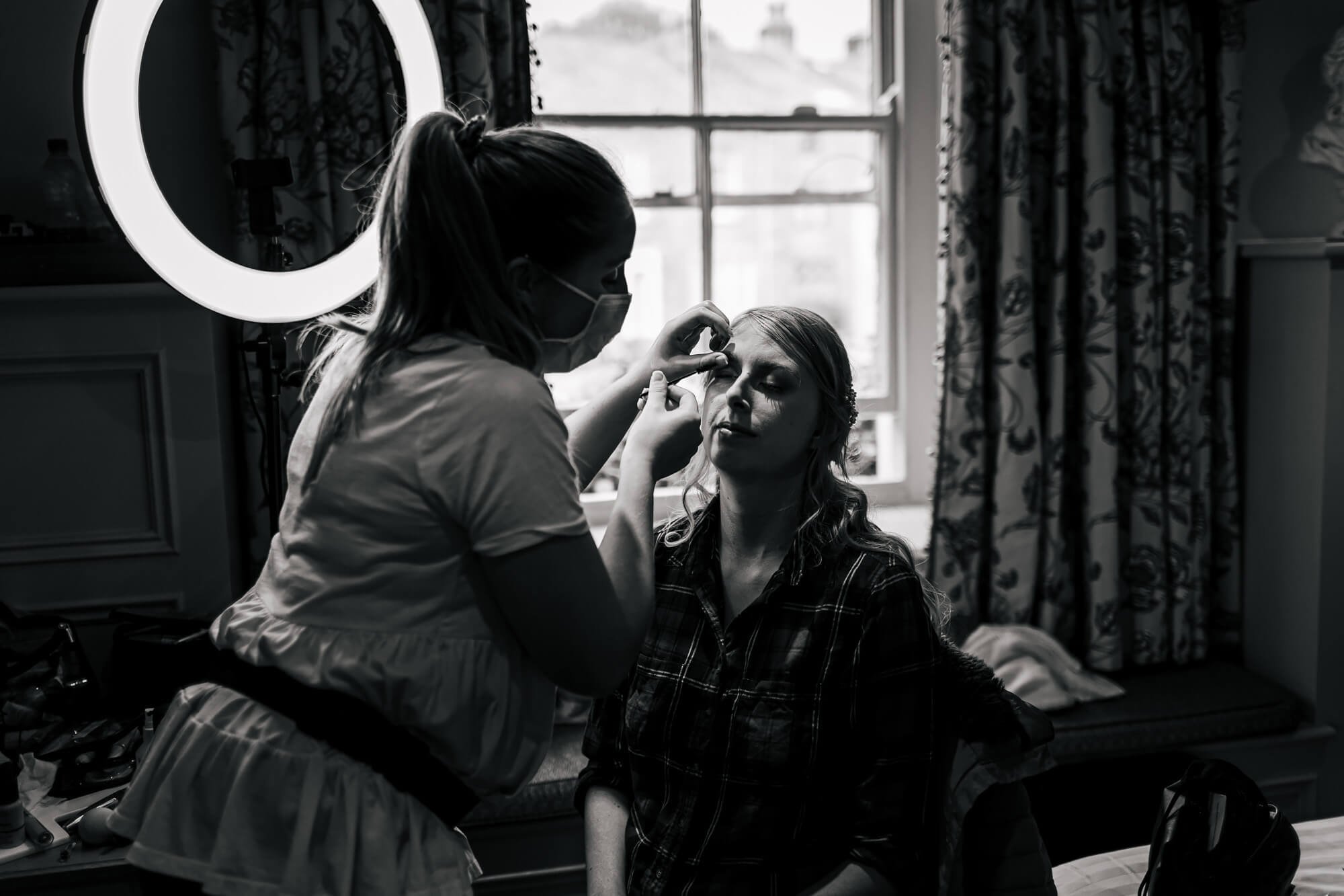 Bride has her make up applied for her wedding