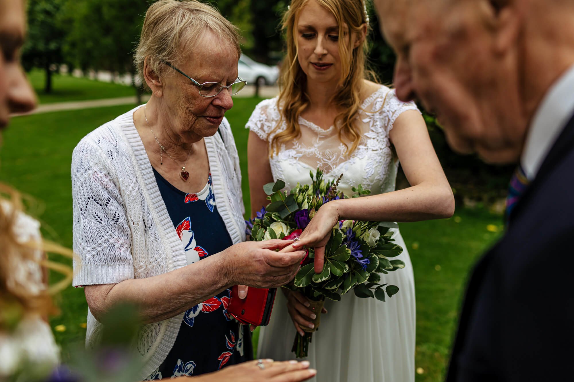 Bride showing off her new wedding ring to family